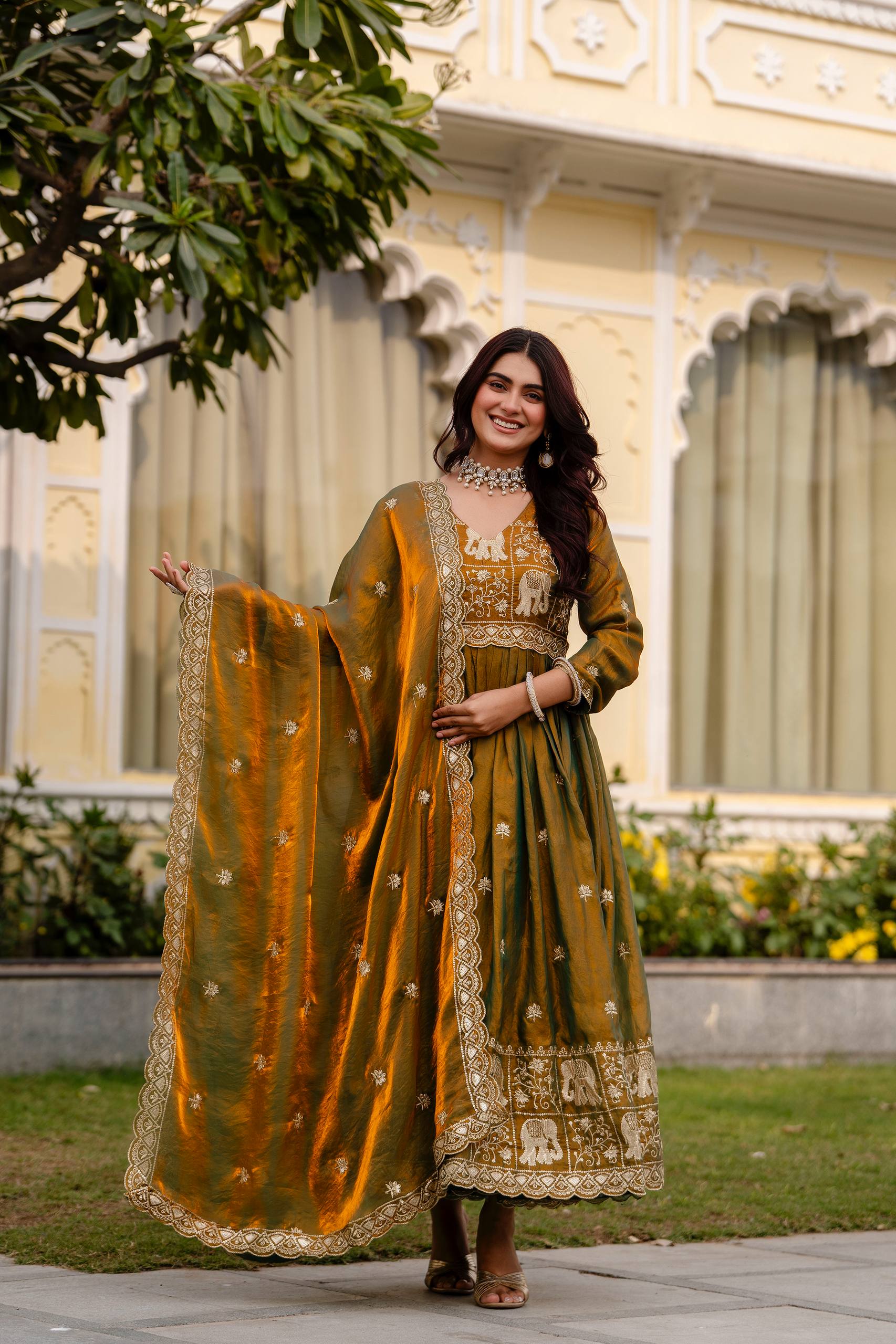Krishnaveni Olive Green Fendy Satin Embroidered Gown with Dupatta Trinari Krishnaveni Olive Green Fendy Satin Embroidered Gown with Dupatta Trinari