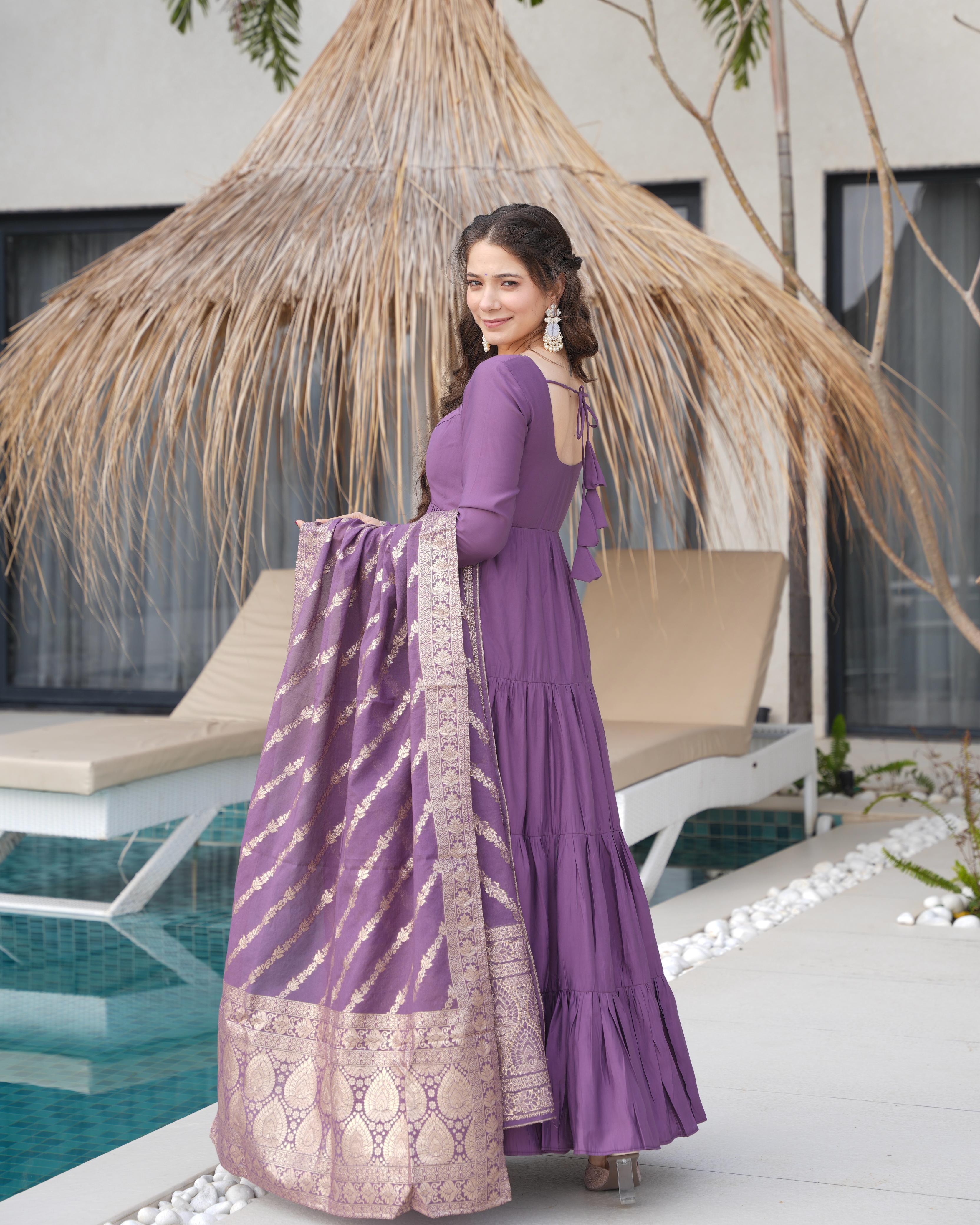 
Purple Roman silk Chanderi Anarkali suit set with Banarasi dupatta, 9-meter flair designer Anarkali gown for wedding and festive wear, Chanderi silk Anarkali with frill design, embroidered Anarkali set for haldi, sangeet, and Eid, purple ethnic wear for women, Banarasi dupatta suit set for engagement or Diwali, readymade Anarkali kurta pant set with heavy flair.