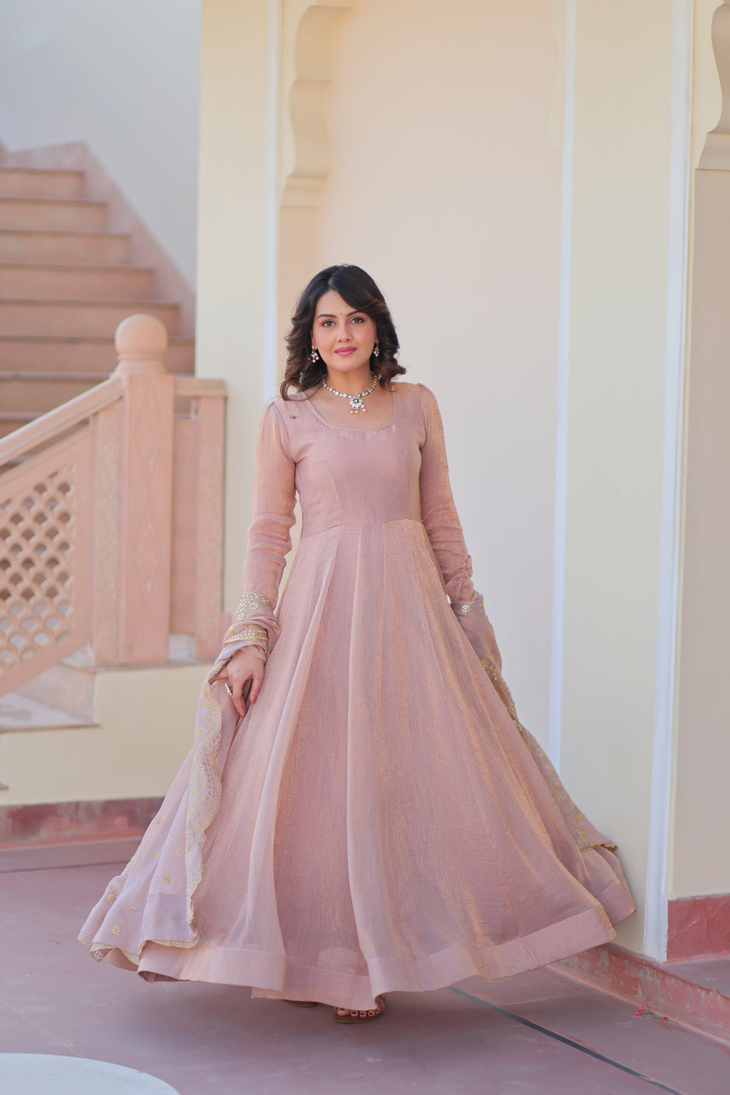 Bhargavi Peach Gown Set – Fendy chiffon gown with 12 kali stitching and 3.5 meter flair, full sleeves, cotton lining, and canvas patta; paired with a sequin and zari embroidered cut-work dupatta – perfect for weddings, sangeet, and festive celebrations.