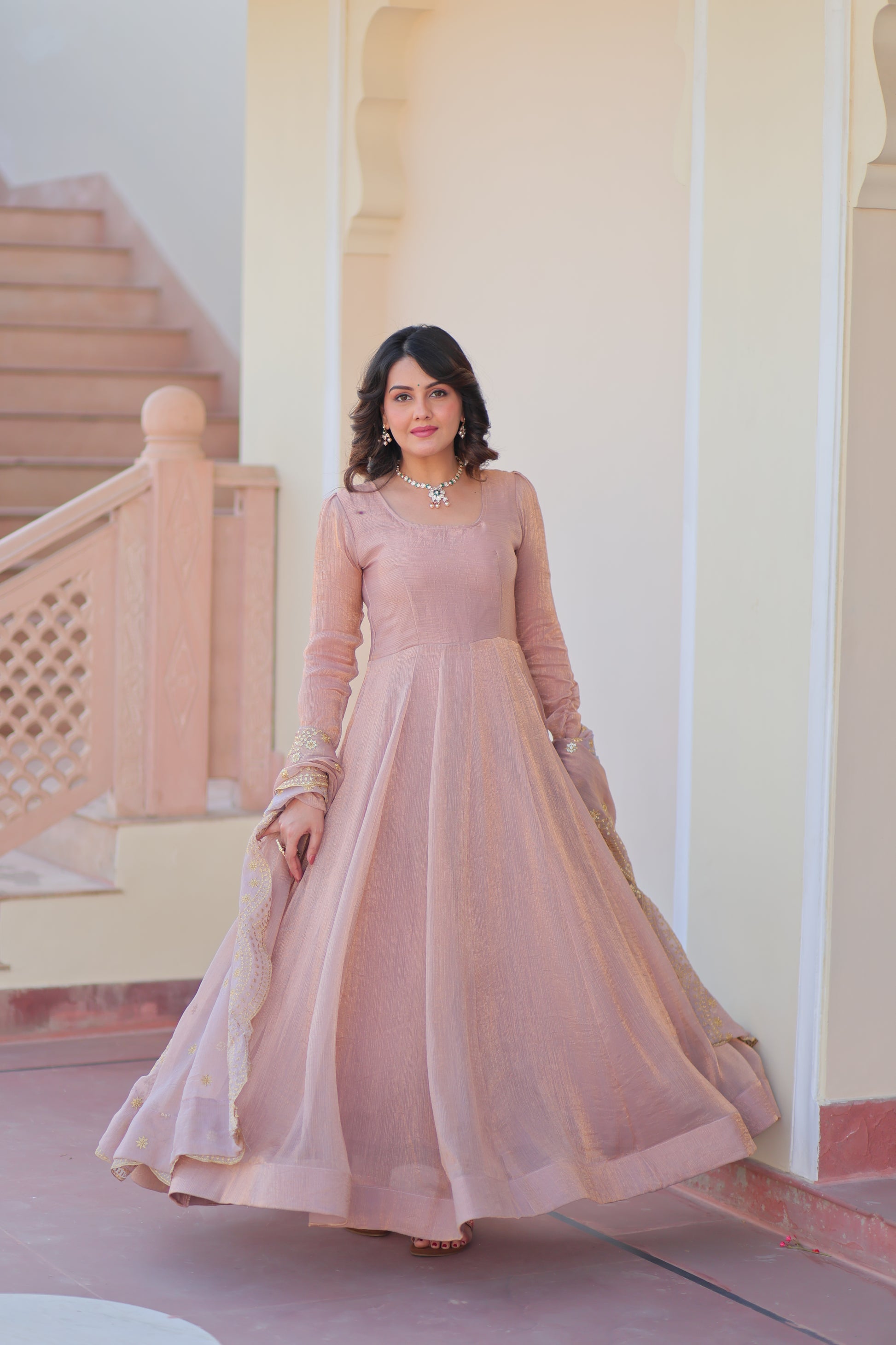 Bhargavi Peach Gown Set – Fendy chiffon gown with 12 kali stitching and 3.5 meter flair, full sleeves, cotton lining, and canvas patta; paired with a sequin and zari embroidered cut-work dupatta – perfect for weddings, sangeet, and festive celebrations.