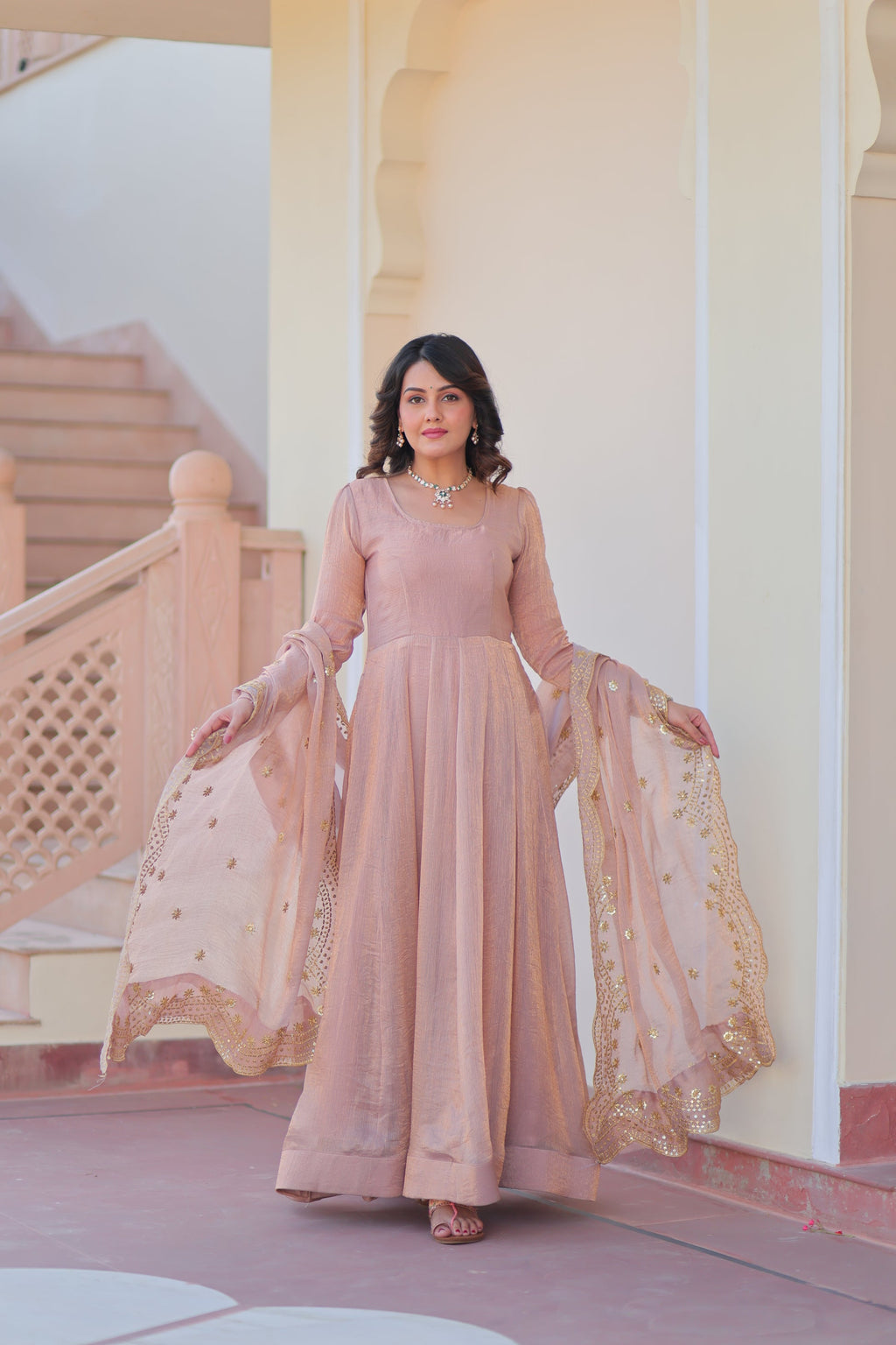 Bhargavi Peach Gown Set – Fendy chiffon gown with 12 kali stitching and 3.5 meter flair, full sleeves, cotton lining, and canvas patta; paired with a sequin and zari embroidered cut-work dupatta – perfect for weddings, sangeet, and festive celebrations.