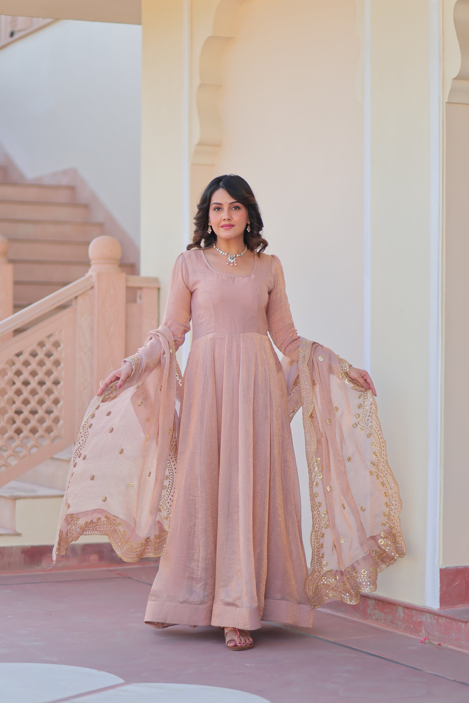 Bhargavi Peach Gown Set – Fendy chiffon gown with 12 kali stitching and 3.5 meter flair, full sleeves, cotton lining, and canvas patta; paired with a sequin and zari embroidered cut-work dupatta – perfect for weddings, sangeet, and festive celebrations.