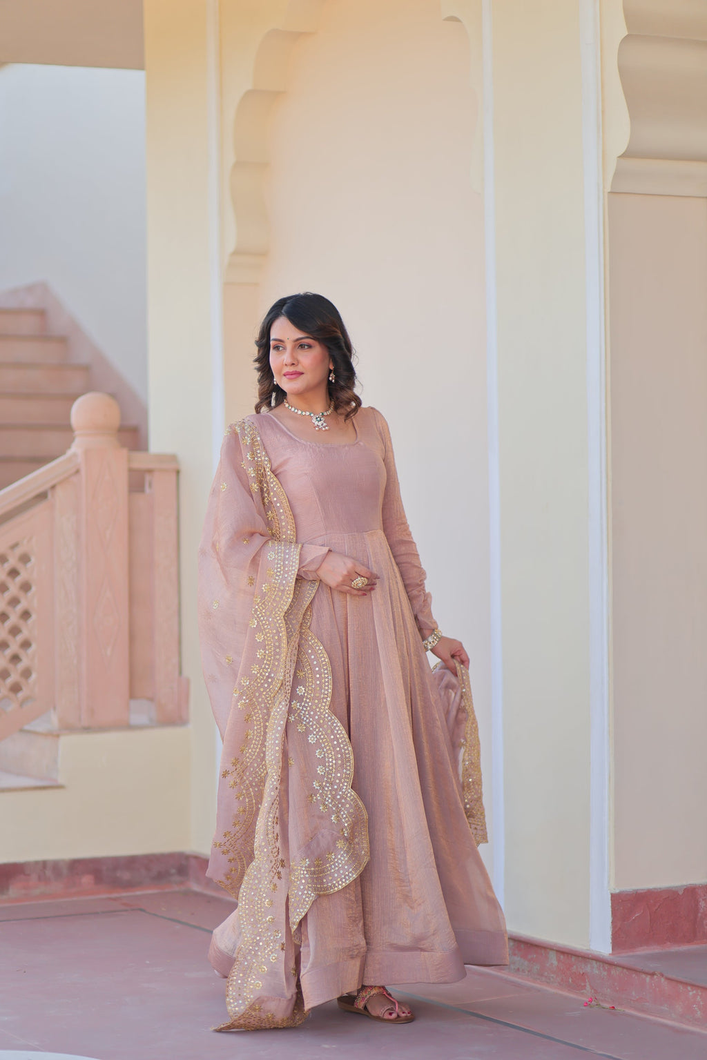 Bhargavi Peach Gown Set – Fendy chiffon gown with 12 kali stitching and 3.5 meter flair, full sleeves, cotton lining, and canvas patta; paired with a sequin and zari embroidered cut-work dupatta – perfect for weddings, sangeet, and festive celebrations.