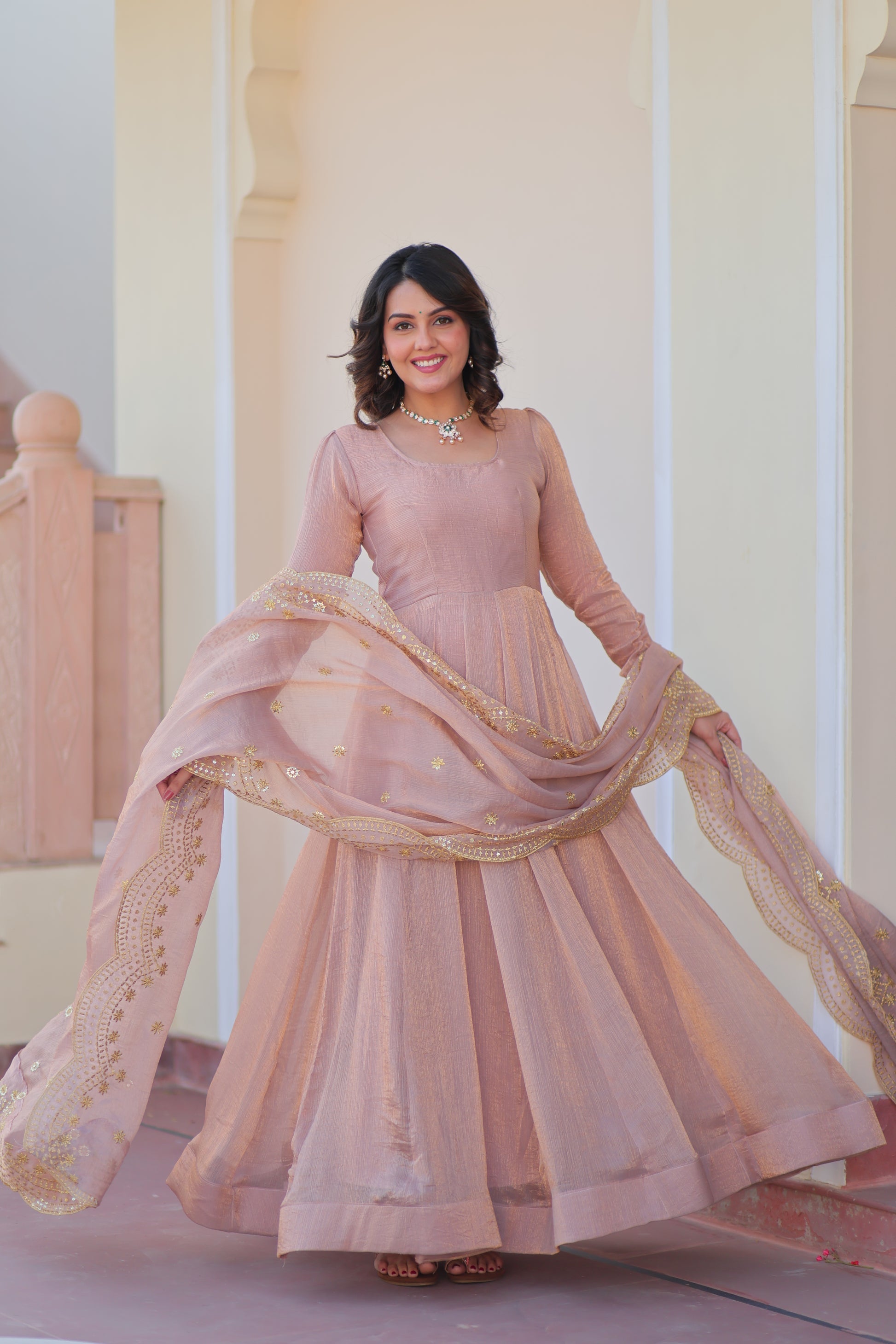 Bhargavi Peach Gown Set – Fendy chiffon gown with 12 kali stitching and 3.5 meter flair, full sleeves, cotton lining, and canvas patta; paired with a sequin and zari embroidered cut-work dupatta – perfect for weddings, sangeet, and festive celebrations.