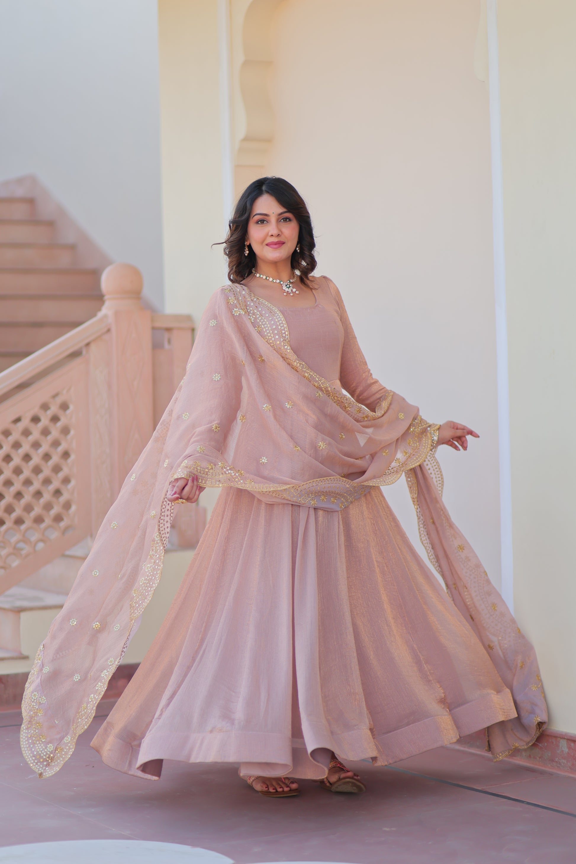 Bhargavi Peach Gown Set – Fendy chiffon gown with 12 kali stitching and 3.5 meter flair, full sleeves, cotton lining, and canvas patta; paired with a sequin and zari embroidered cut-work dupatta – perfect for weddings, sangeet, and festive celebrations.