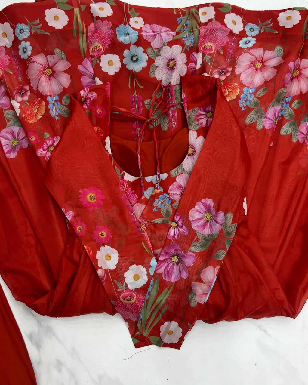 Darshika Orange Organza Floral Printed Anarkali Suit Set – fully stitched 4+ meter flared Anarkali in soft organza silk with badla zari and floral print work, paired with micro cotton pant and matching organza dupatta featuring gota patti lace; perfect ethnic outfit for weddings, festivals, and traditional occasions.