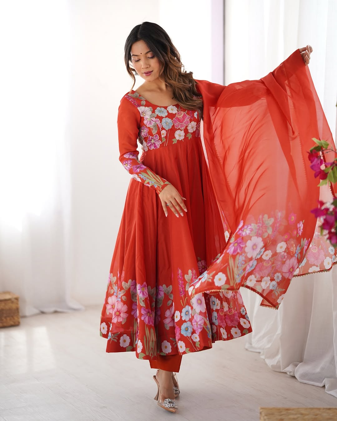 Darshika Orange Organza Floral Printed Anarkali Suit Set – fully stitched 4+ meter flared Anarkali in soft organza silk with badla zari and floral print work, paired with micro cotton pant and matching organza dupatta featuring gota patti lace; perfect ethnic outfit for weddings, festivals, and traditional occasions.