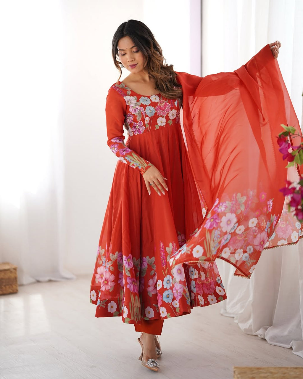 Darshika Orange Organza Floral Printed Anarkali Suit Set – fully stitched 4+ meter flared Anarkali in soft organza silk with badla zari and floral print work, paired with micro cotton pant and matching organza dupatta featuring gota patti lace; perfect ethnic outfit for weddings, festivals, and traditional occasions.