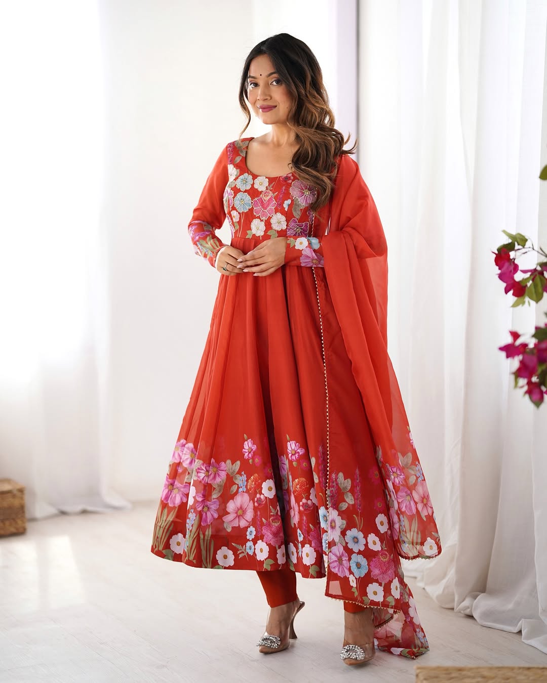 Darshika Orange Organza Floral Printed Anarkali Suit Set – fully stitched 4+ meter flared Anarkali in soft organza silk with badla zari and floral print work, paired with micro cotton pant and matching organza dupatta featuring gota patti lace; perfect ethnic outfit for weddings, festivals, and traditional occasions.