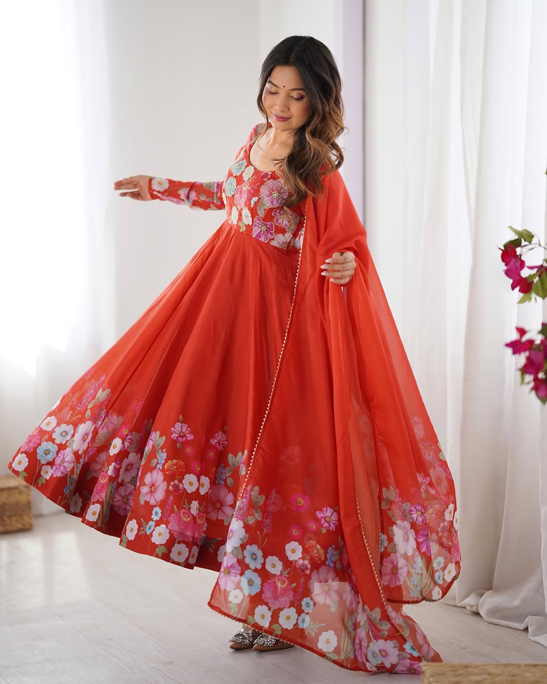 Darshika Orange Organza Floral Printed Anarkali Suit Set – fully stitched 4+ meter flared Anarkali in soft organza silk with badla zari and floral print work, paired with micro cotton pant and matching organza dupatta featuring gota patti lace; perfect ethnic outfit for weddings, festivals, and traditional occasions.