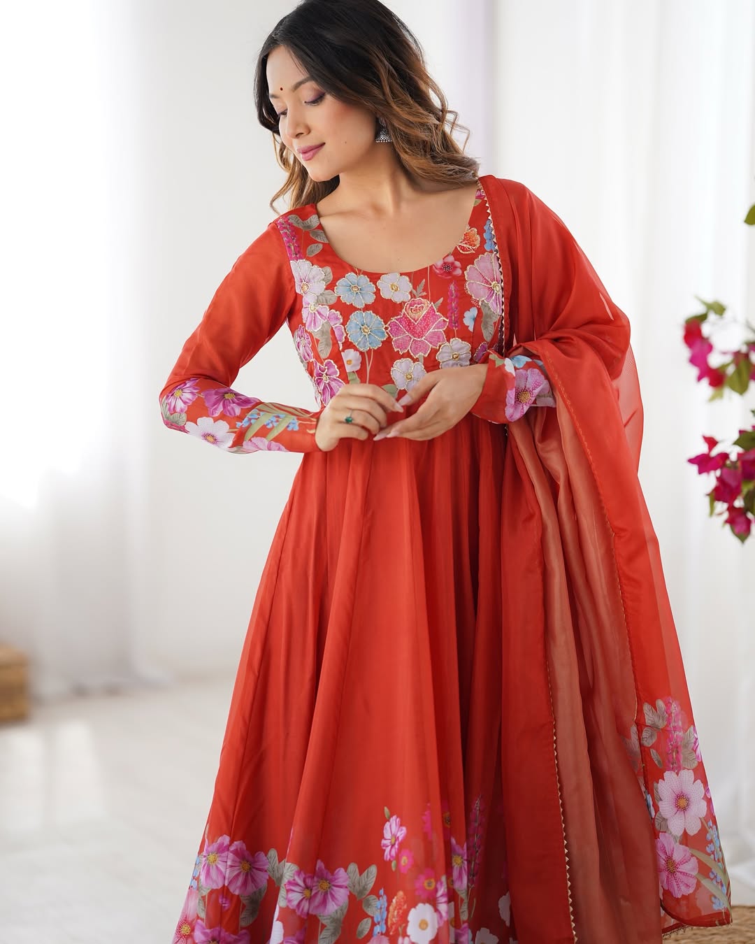 Darshika Orange Organza Floral Printed Anarkali Suit Set – fully stitched 4+ meter flared Anarkali in soft organza silk with badla zari and floral print work, paired with micro cotton pant and matching organza dupatta featuring gota patti lace; perfect ethnic outfit for weddings, festivals, and traditional occasions.