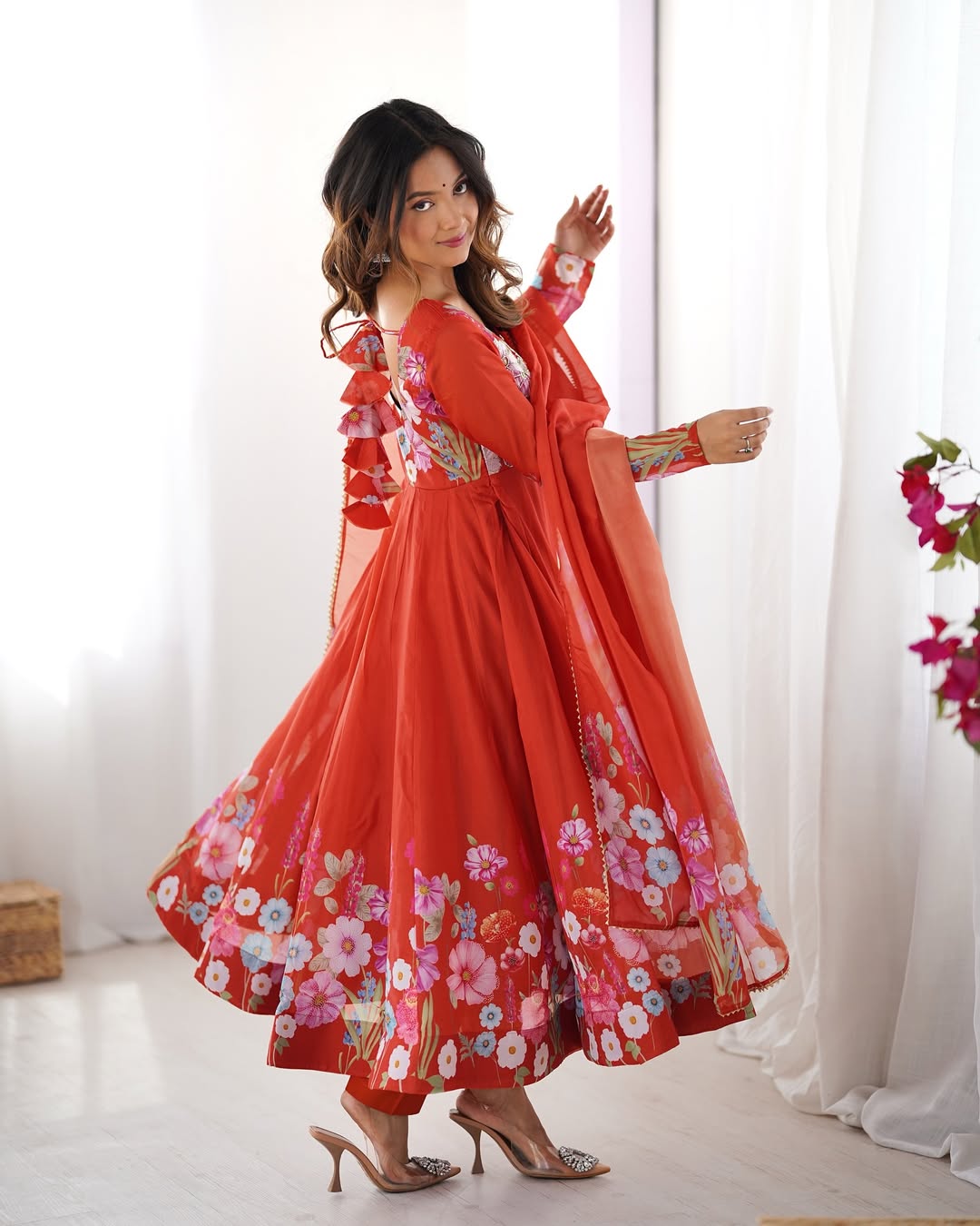 Darshika Orange Organza Floral Printed Anarkali Suit Set – fully stitched 4+ meter flared Anarkali in soft organza silk with badla zari and floral print work, paired with micro cotton pant and matching organza dupatta featuring gota patti lace; perfect ethnic outfit for weddings, festivals, and traditional occasions.