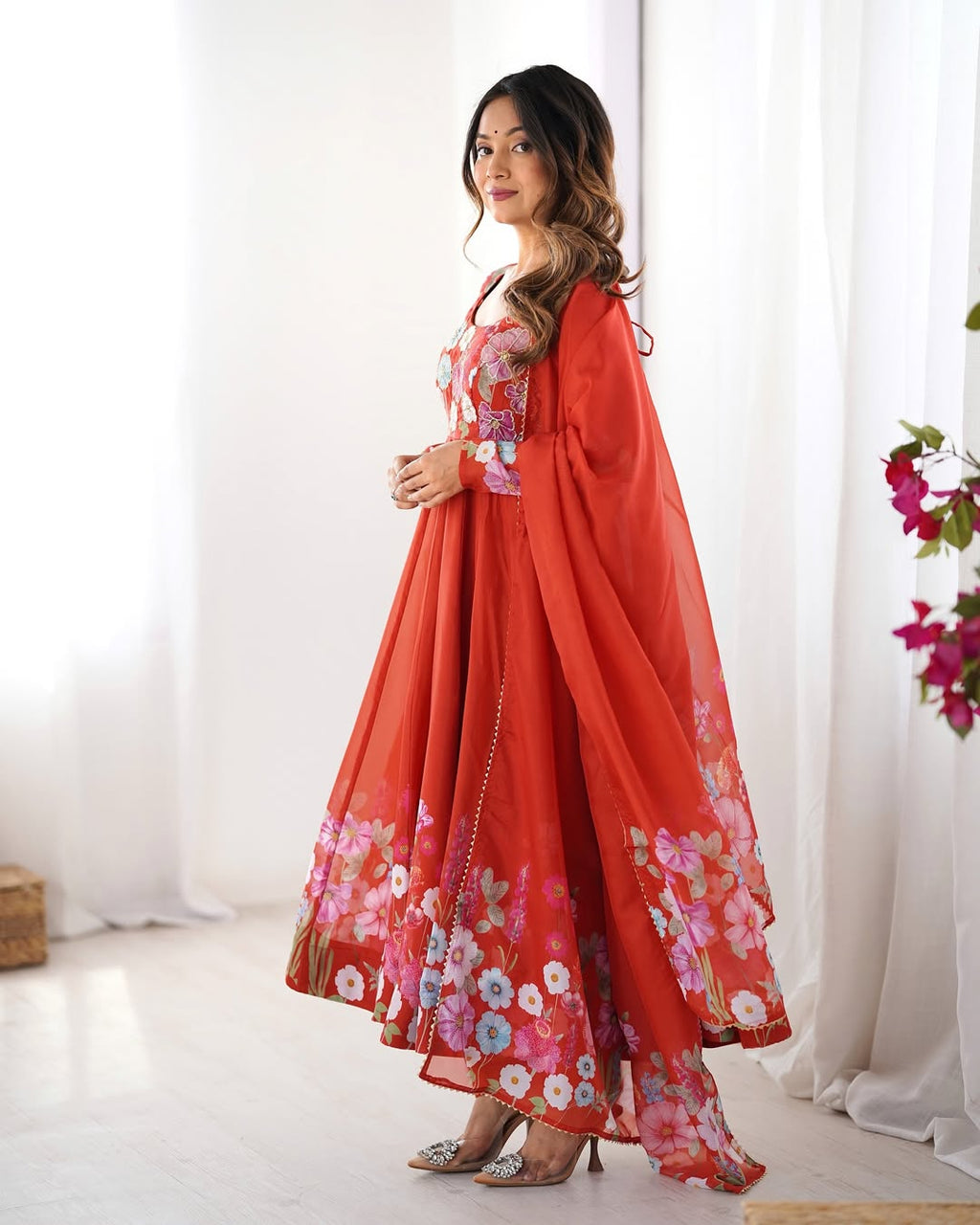 Darshika Orange Organza Floral Printed Anarkali Suit Set – fully stitched 4+ meter flared Anarkali in soft organza silk with badla zari and floral print work, paired with micro cotton pant and matching organza dupatta featuring gota patti lace; perfect ethnic outfit for weddings, festivals, and traditional occasions.