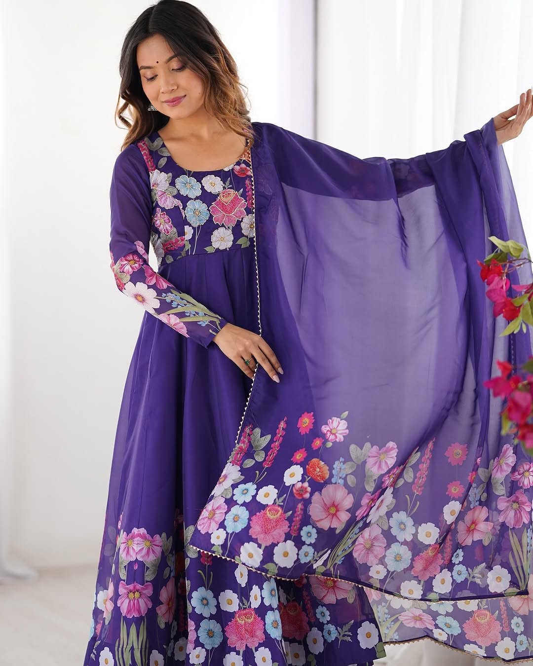  Darshika purple organza silk floral printed Anarkali suit set featuring zari work and Gota Patti lace border on the dupatta, paired with micro cotton pants – perfect for weddings, festivals, and luxury Indian ethnic wear in 2025.