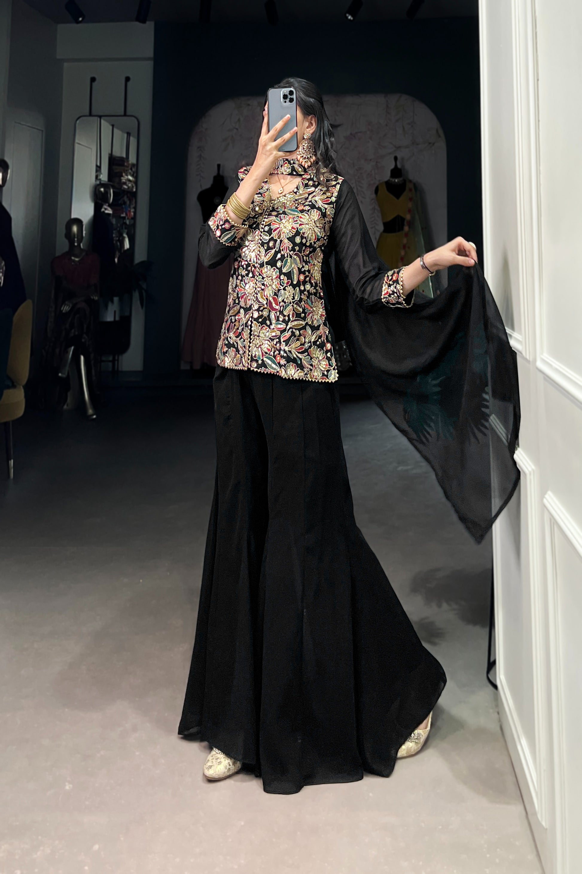 Kanvika Black Kurta Palazzo Set crafted from premium georgette fabric, featuring a short embroidered kurta with sequins and thread embroidery, full sleeves, and a soft micro cotton lining. Paired with plain georgette palazzo pants with an elastic waistband for comfort and a lightweight embroidered georgette dupatta. Ideal for festive wear, party wear, and wedding functions, this elegant ethnic ensemble blends tradition with contemporary sophistication