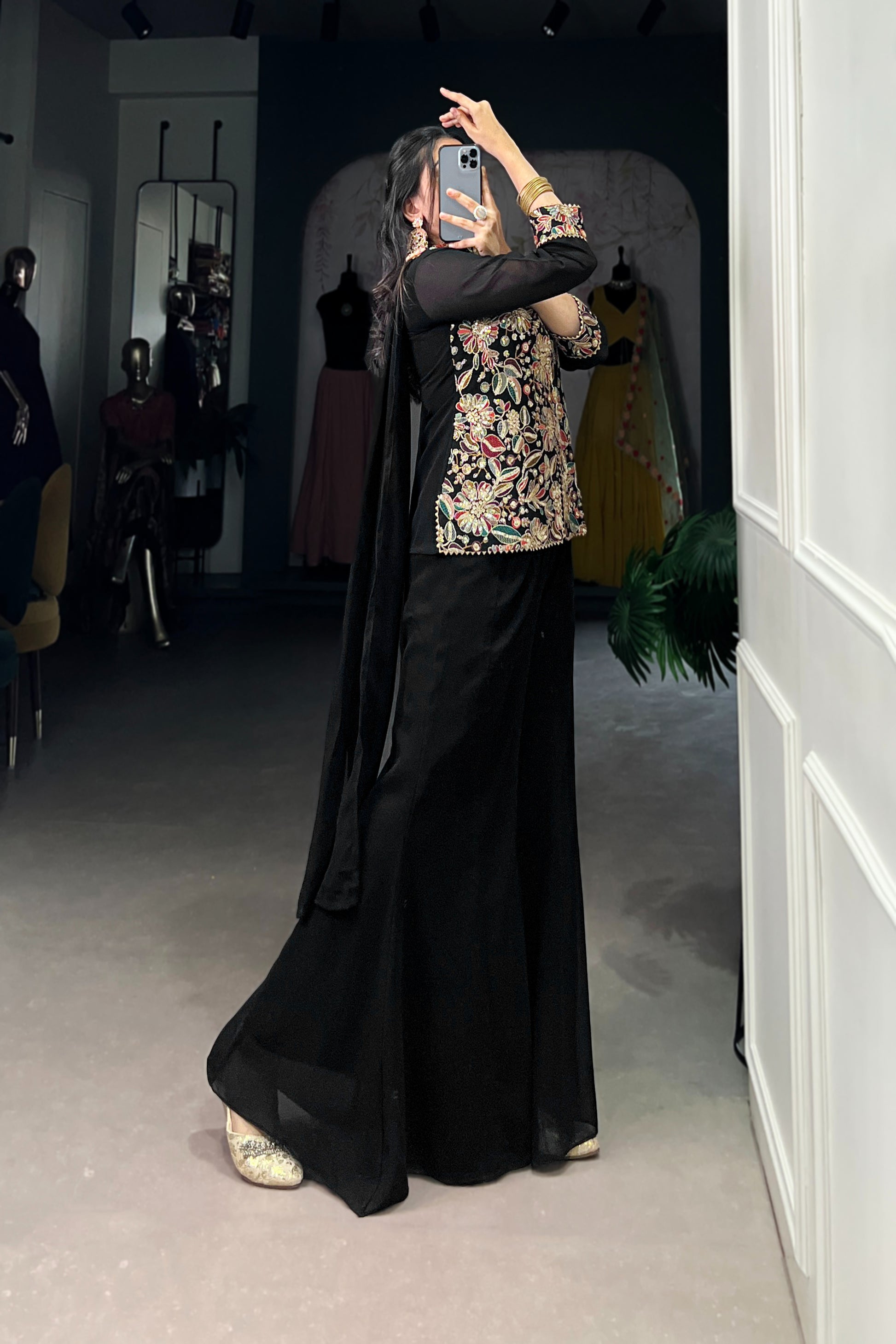 Kanvika Black Kurta Palazzo Set crafted from premium georgette fabric, featuring a short embroidered kurta with sequins and thread embroidery, full sleeves, and a soft micro cotton lining. Paired with plain georgette palazzo pants with an elastic waistband for comfort and a lightweight embroidered georgette dupatta. Ideal for festive wear, party wear, and wedding functions, this elegant ethnic ensemble blends tradition with contemporary sophistication