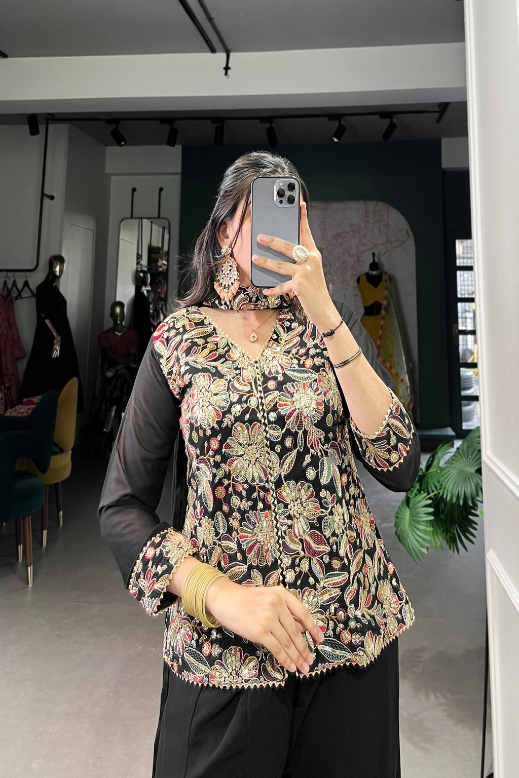 Kanvika Black Kurta Palazzo Set crafted from premium georgette fabric, featuring a short embroidered kurta with sequins and thread embroidery, full sleeves, and a soft micro cotton lining. Paired with plain georgette palazzo pants with an elastic waistband for comfort and a lightweight embroidered georgette dupatta. Ideal for festive wear, party wear, and wedding functions, this elegant ethnic ensemble blends tradition with contemporary sophistication