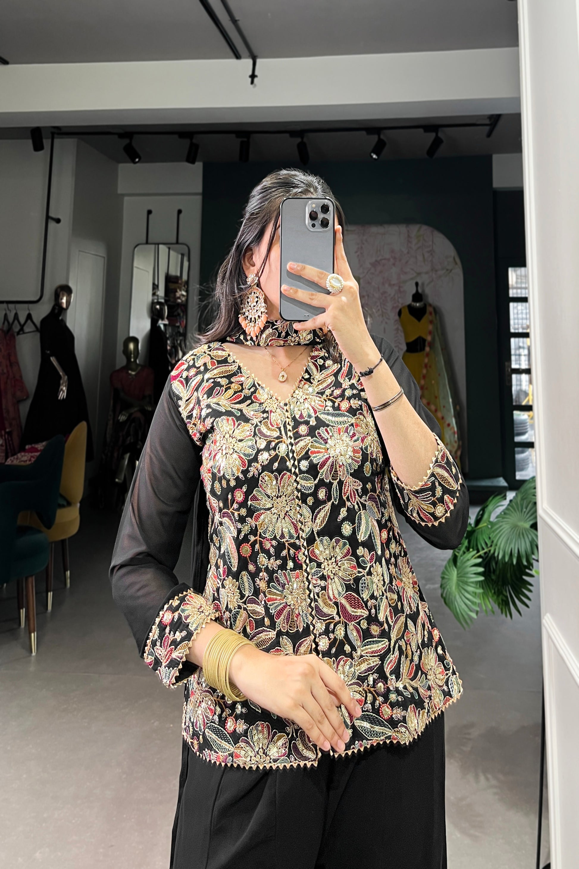 Kanvika Black Kurta Palazzo Set crafted from premium georgette fabric, featuring a short embroidered kurta with sequins and thread embroidery, full sleeves, and a soft micro cotton lining. Paired with plain georgette palazzo pants with an elastic waistband for comfort and a lightweight embroidered georgette dupatta. Ideal for festive wear, party wear, and wedding functions, this elegant ethnic ensemble blends tradition with contemporary sophistication