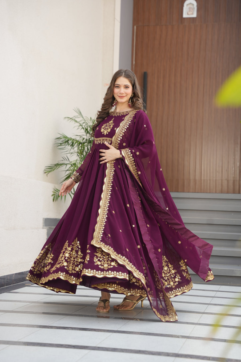 Wine-colored embroidered Anarkali gown set for women with dupatta, luxurious ethnic outfit featuring intricate zari and sequin embroidery, full-length party wear Anarkali with flared silhouette and elegant neckline, ideal for weddings, festive celebrations, and traditional Indian occasions, readymade stitched gown for 2025 designer ethnic fashion trends.