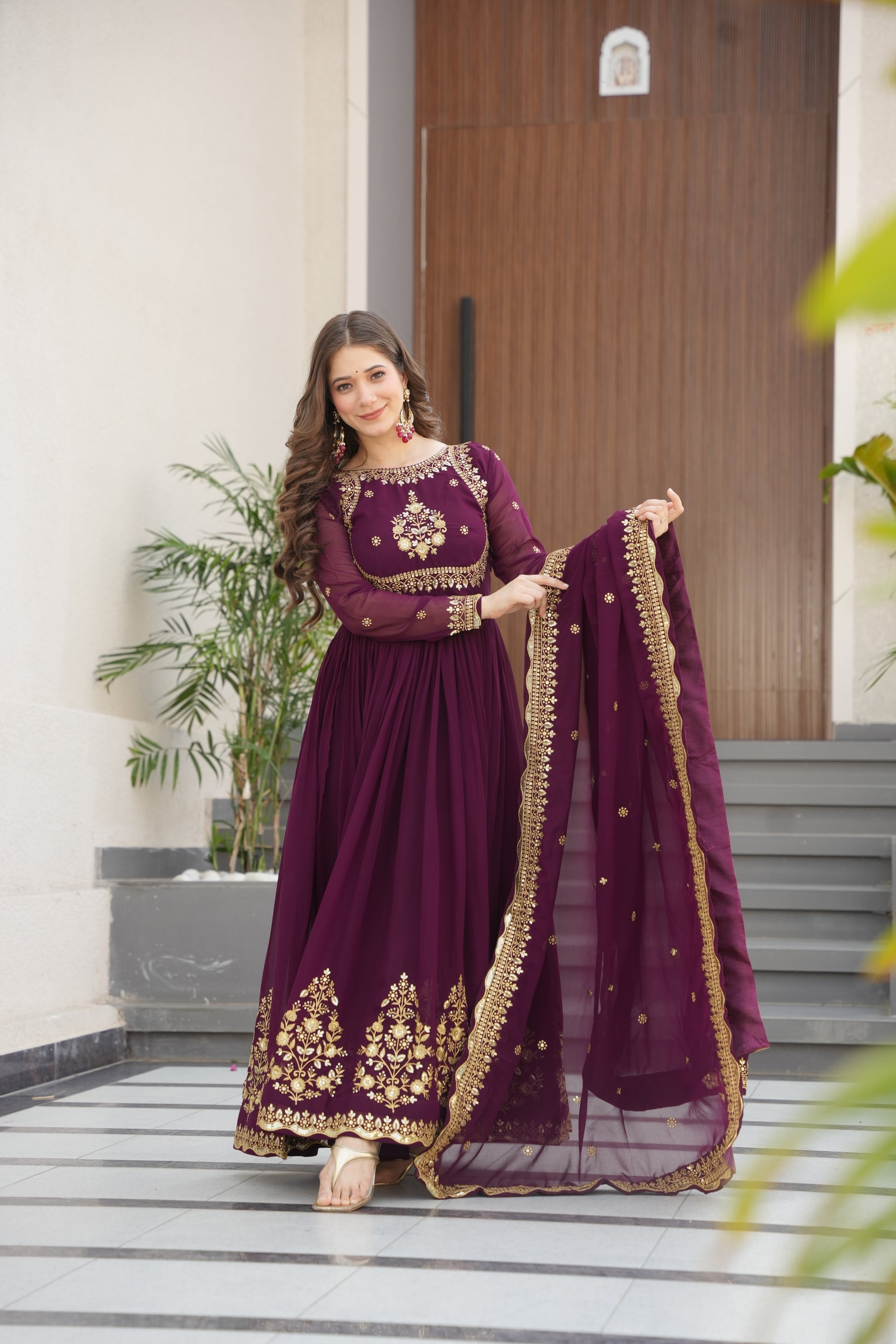Wine-colored embroidered Anarkali gown set for women with dupatta, luxurious ethnic outfit featuring intricate zari and sequin embroidery, full-length party wear Anarkali with flared silhouette and elegant neckline, ideal for weddings, festive celebrations, and traditional Indian occasions, readymade stitched gown for 2025 designer ethnic fashion trends.