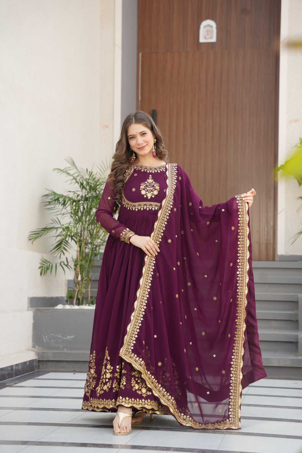 Wine-colored embroidered Anarkali gown set for women with dupatta, luxurious ethnic outfit featuring intricate zari and sequin embroidery, full-length party wear Anarkali with flared silhouette and elegant neckline, ideal for weddings, festive celebrations, and traditional Indian occasions, readymade stitched gown for 2025 designer ethnic fashion trends.