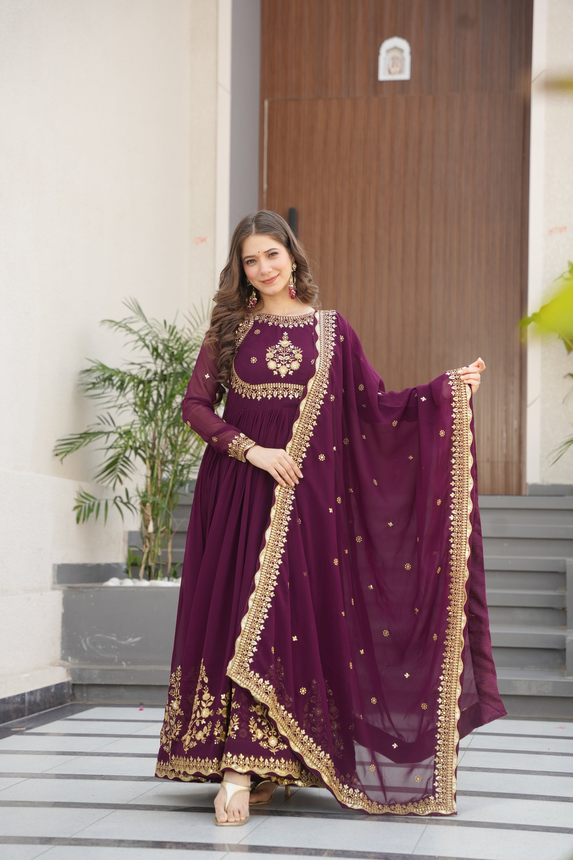Wine-colored embroidered Anarkali gown set for women with dupatta, luxurious ethnic outfit featuring intricate zari and sequin embroidery, full-length party wear Anarkali with flared silhouette and elegant neckline, ideal for weddings, festive celebrations, and traditional Indian occasions, readymade stitched gown for 2025 designer ethnic fashion trends.