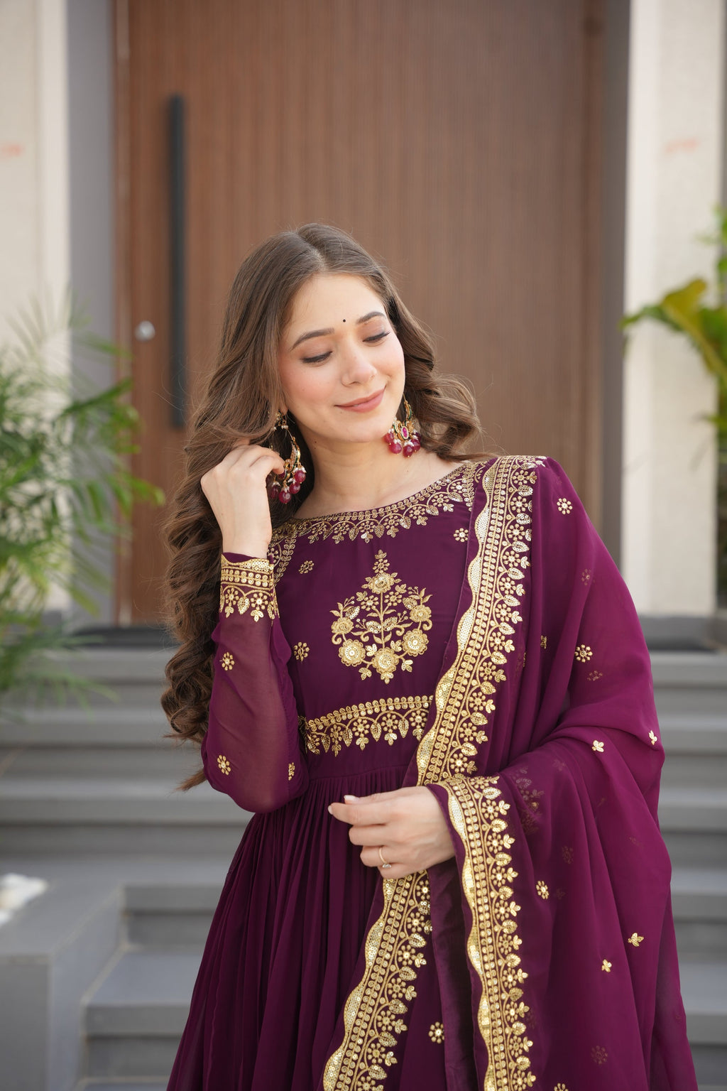 Wine-colored embroidered Anarkali gown set for women with dupatta, luxurious ethnic outfit featuring intricate zari and sequin embroidery, full-length party wear Anarkali with flared silhouette and elegant neckline, ideal for weddings, festive celebrations, and traditional Indian occasions, readymade stitched gown for 2025 designer ethnic fashion trends.