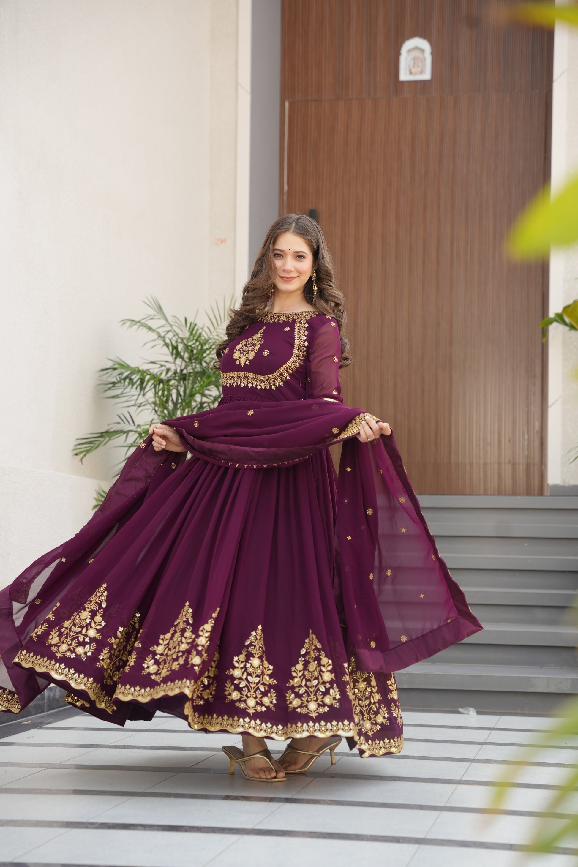 Wine-colored embroidered Anarkali gown set for women with dupatta, luxurious ethnic outfit featuring intricate zari and sequin embroidery, full-length party wear Anarkali with flared silhouette and elegant neckline, ideal for weddings, festive celebrations, and traditional Indian occasions, readymade stitched gown for 2025 designer ethnic fashion trends.
