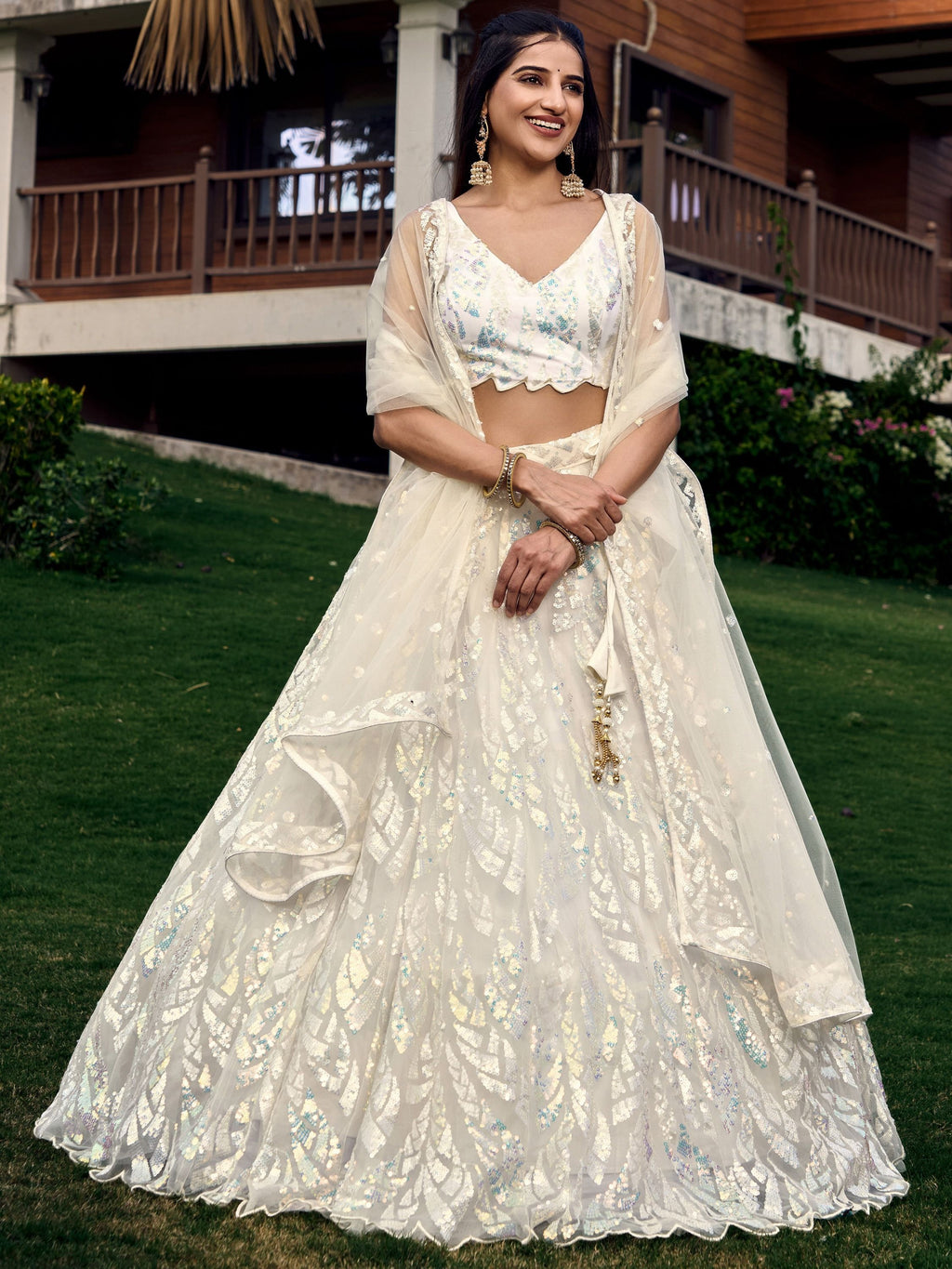 Off white net sequins embroidered party wear lehenga choli