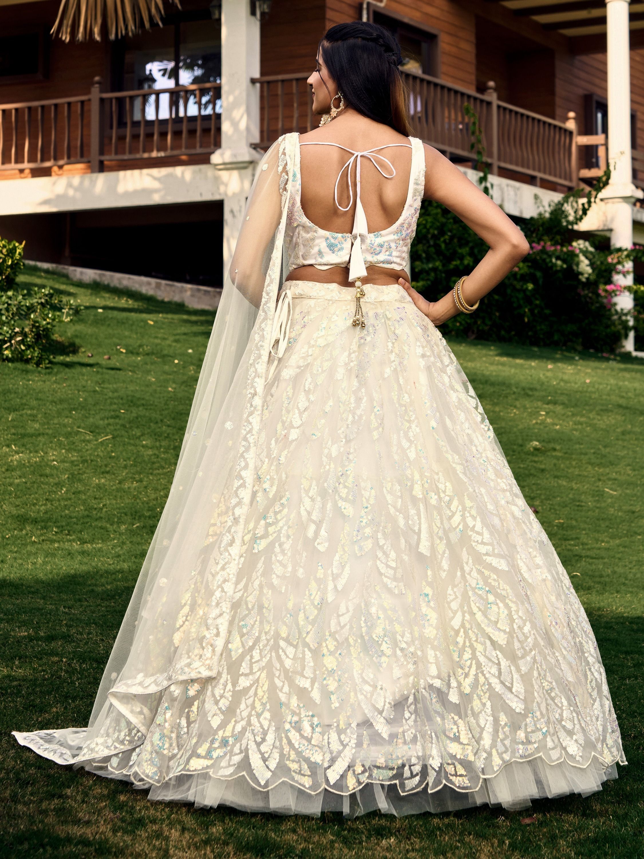 Off white net sequins embroidered party wear lehenga choli