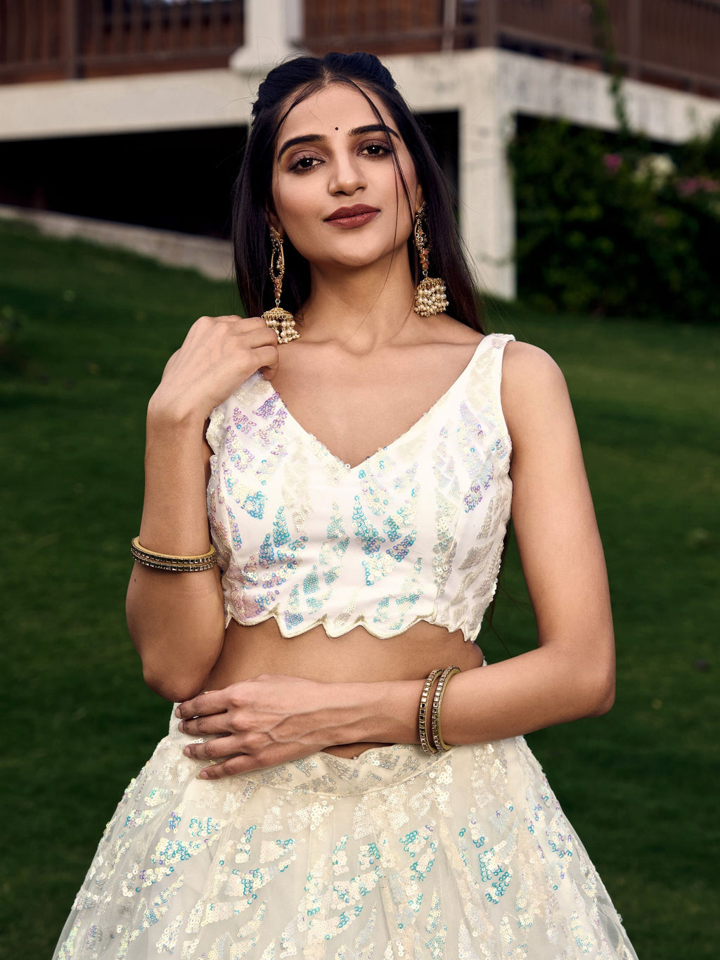 Off white net sequins embroidered party wear lehenga choli