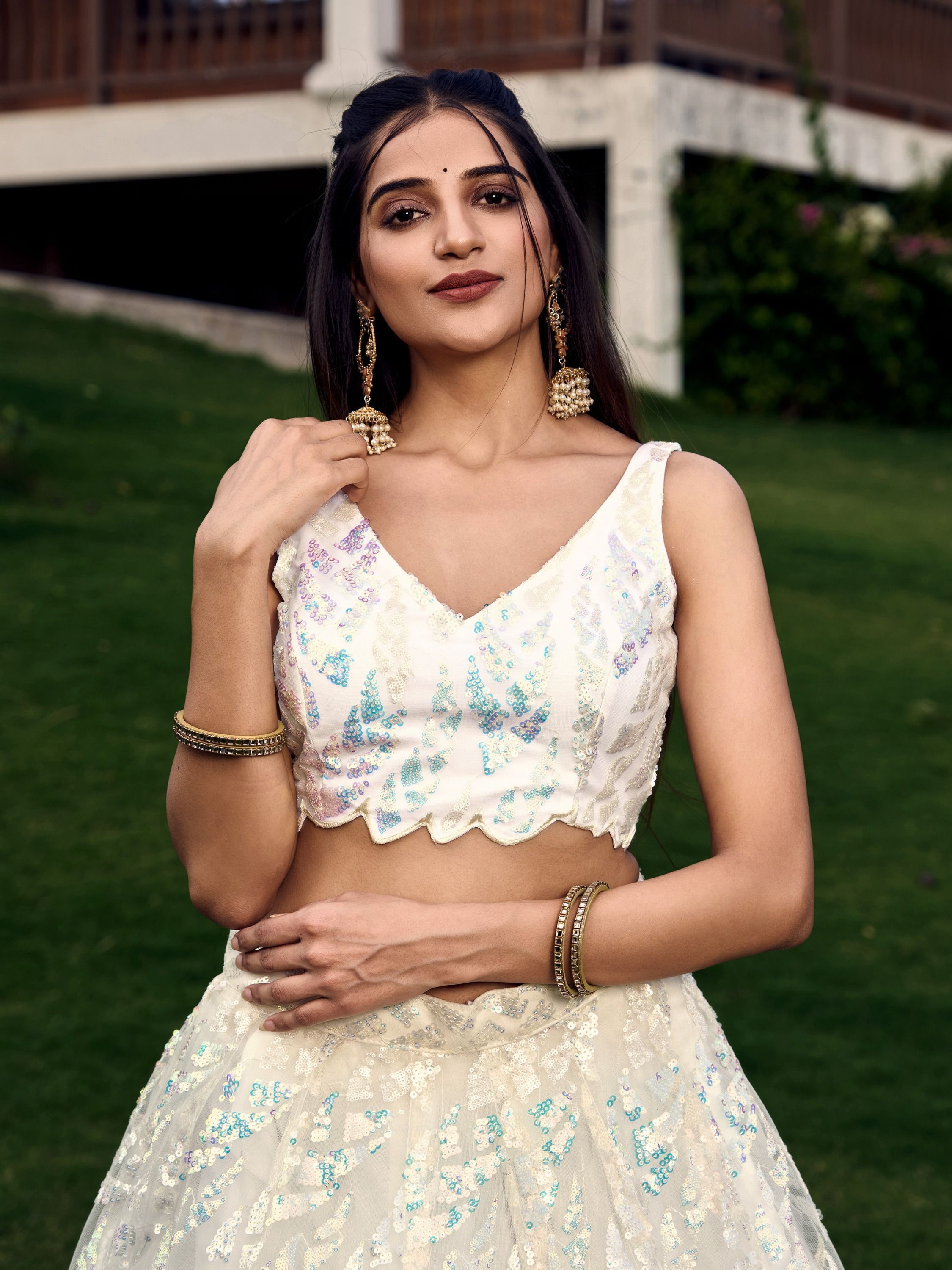 Off white net sequins embroidered party wear lehenga choli