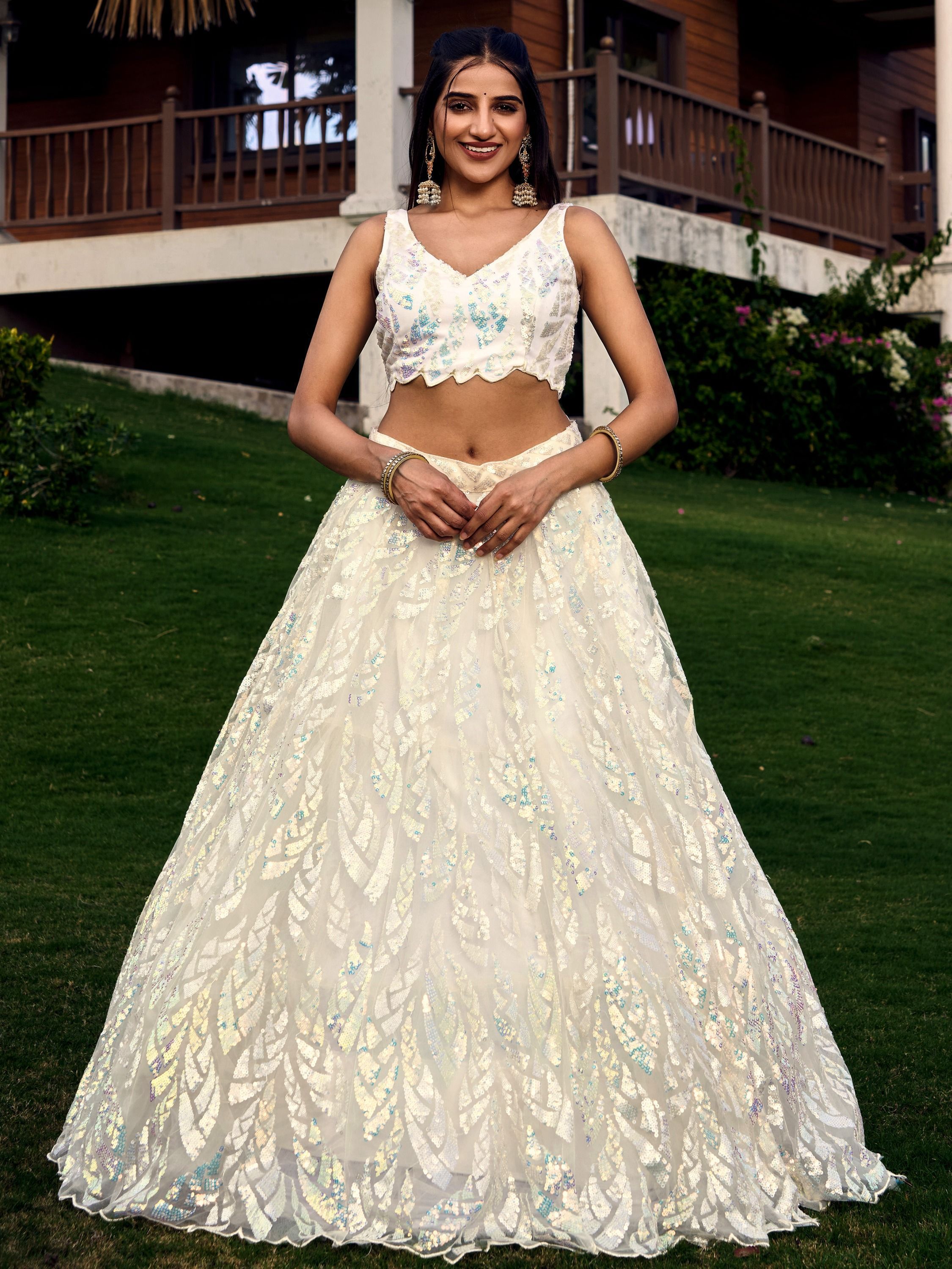 Off white net sequins embroidered party wear lehenga choli