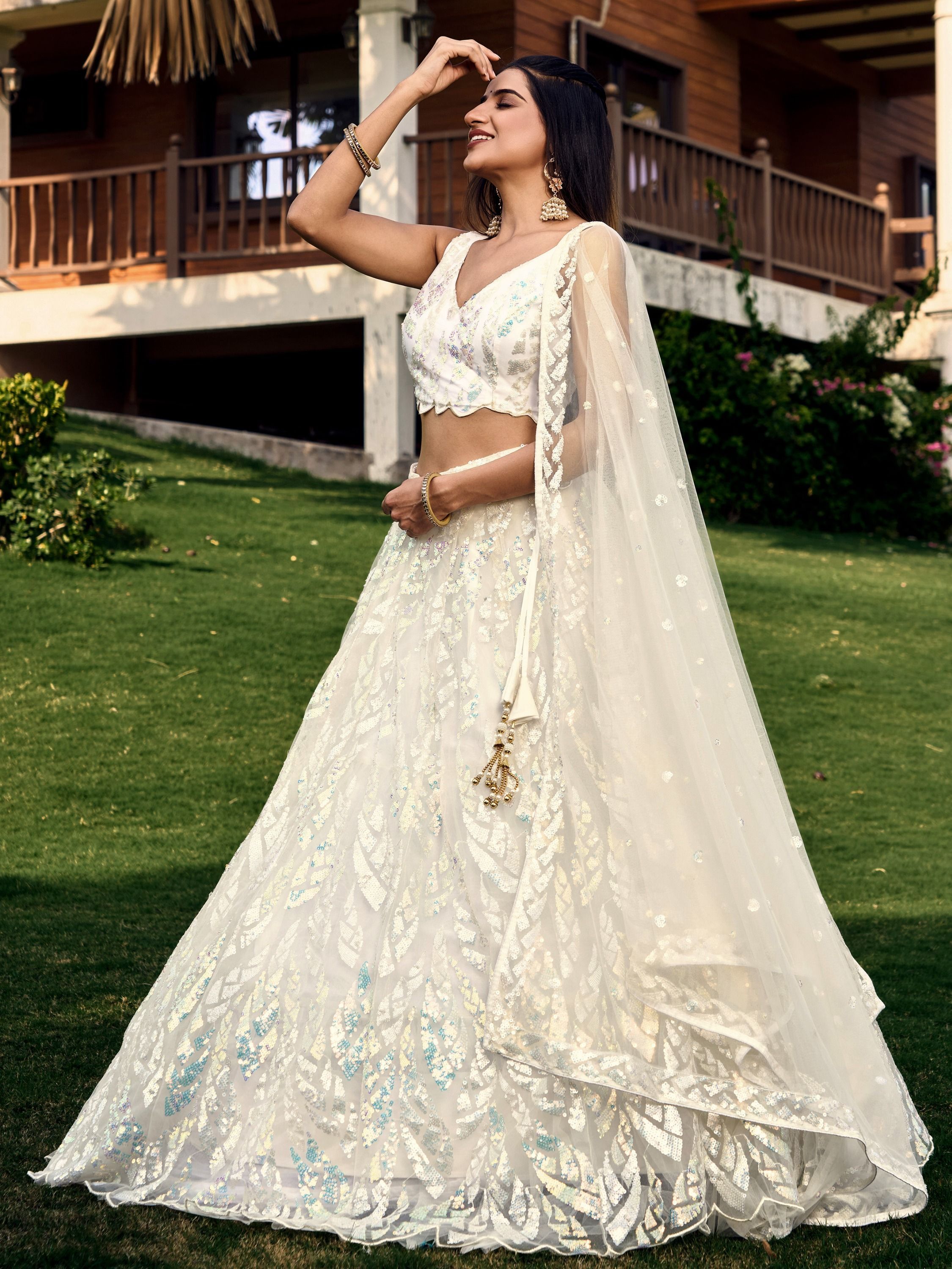 Off White soft net lehenga choli with heavy multi sequins embroidery and lace border dupatta perfect for weddings receptions and glam parties