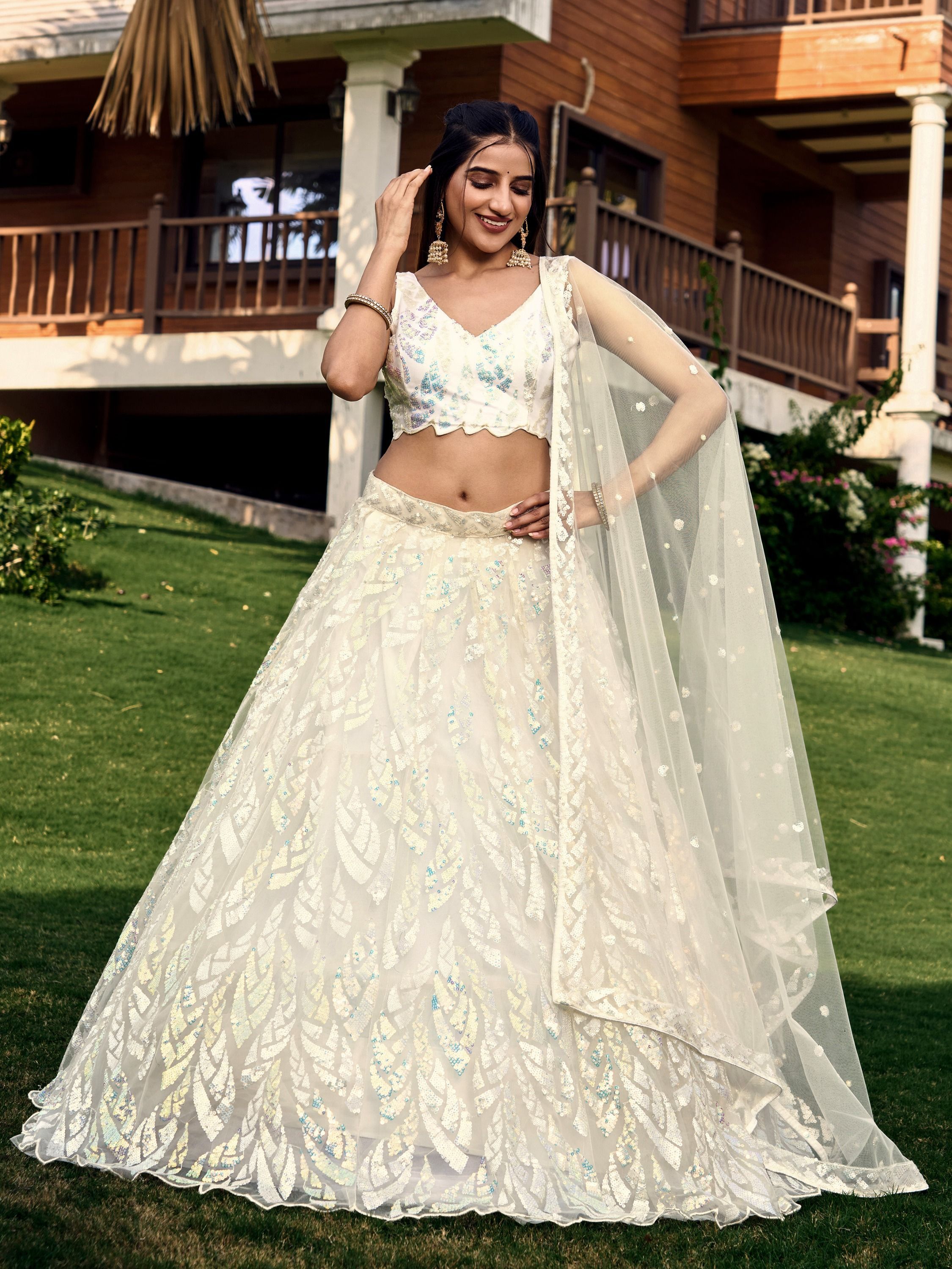 Off White soft net lehenga choli with heavy multi sequins embroidery and lace border dupatta perfect for weddings receptions and glam parties