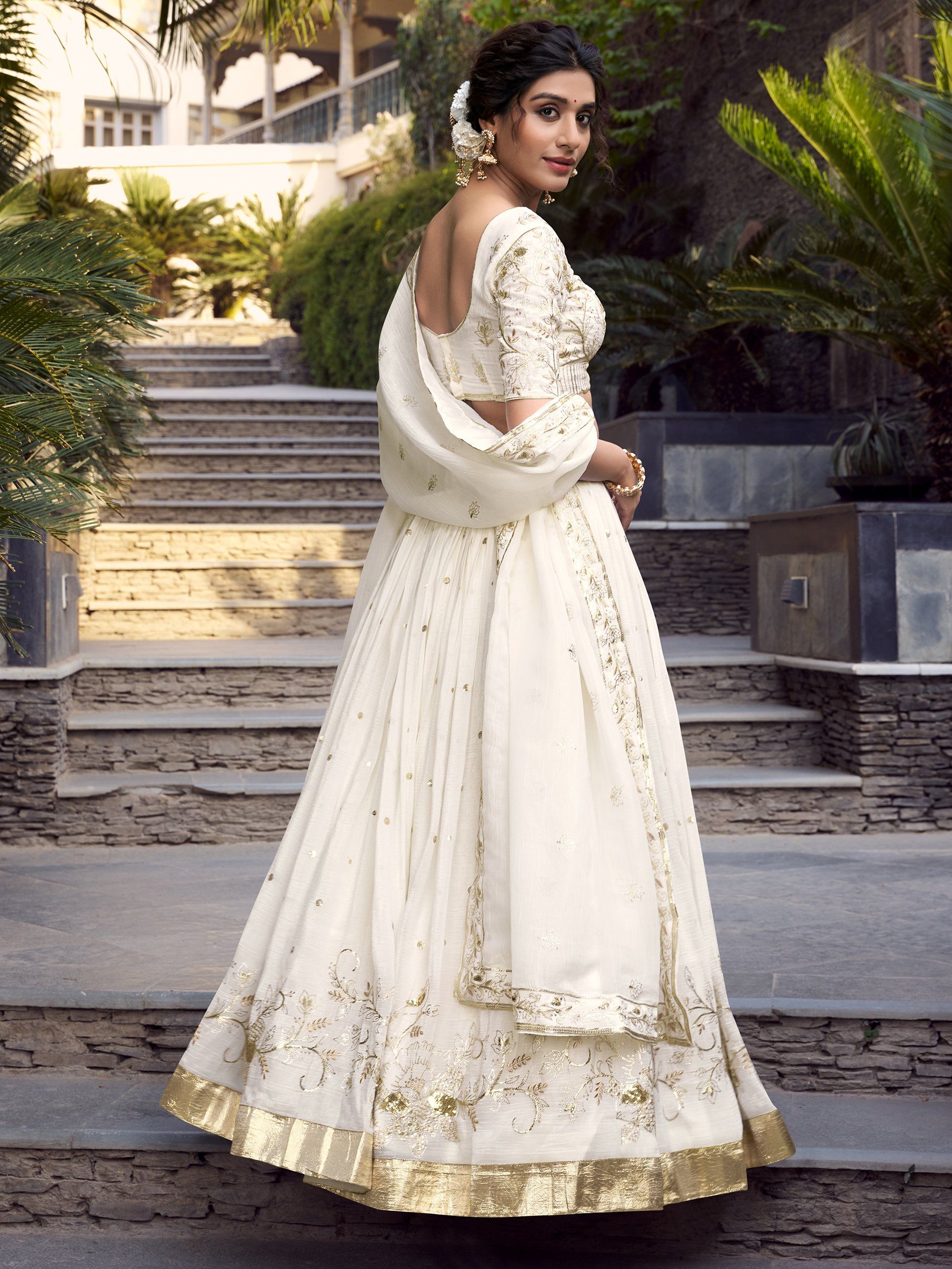 Off-white silver glossy lehenga choli set with sequin, embroidery, and foil work; includes 3.5-meter flared lehenga, unstitched blouse, and embroidered dupatta – perfect for weddings and festive events