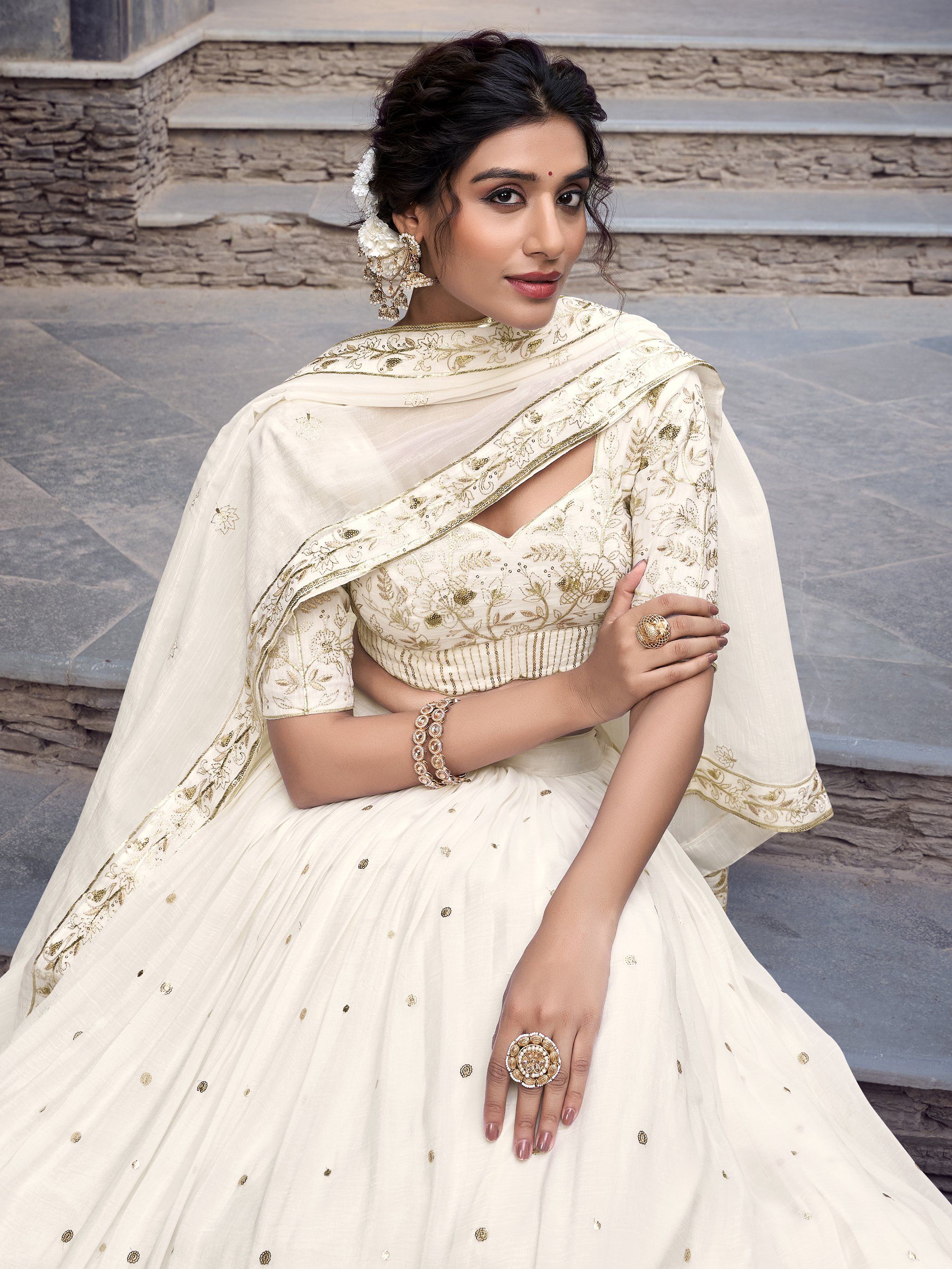 Off-white silver glossy lehenga choli set with sequin, embroidery, and foil work; includes 3.5-meter flared lehenga, unstitched blouse, and embroidered dupatta – perfect for weddings and festive events