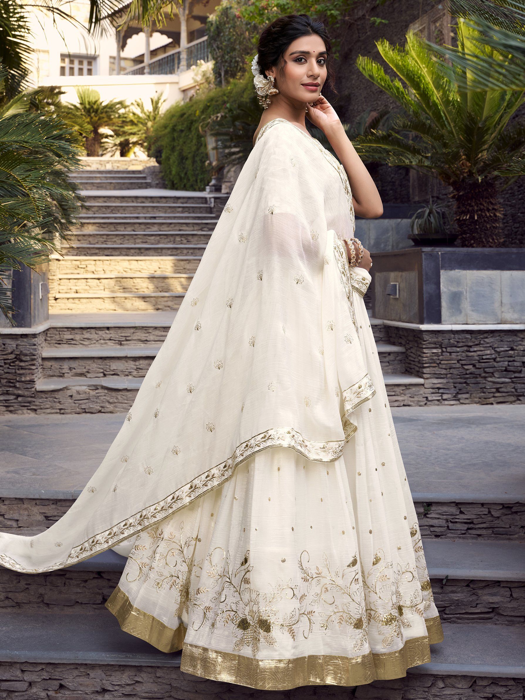 Off-white silver glossy lehenga choli set with sequin, embroidery, and foil work; includes 3.5-meter flared lehenga, unstitched blouse, and embroidered dupatta – perfect for weddings and festive events