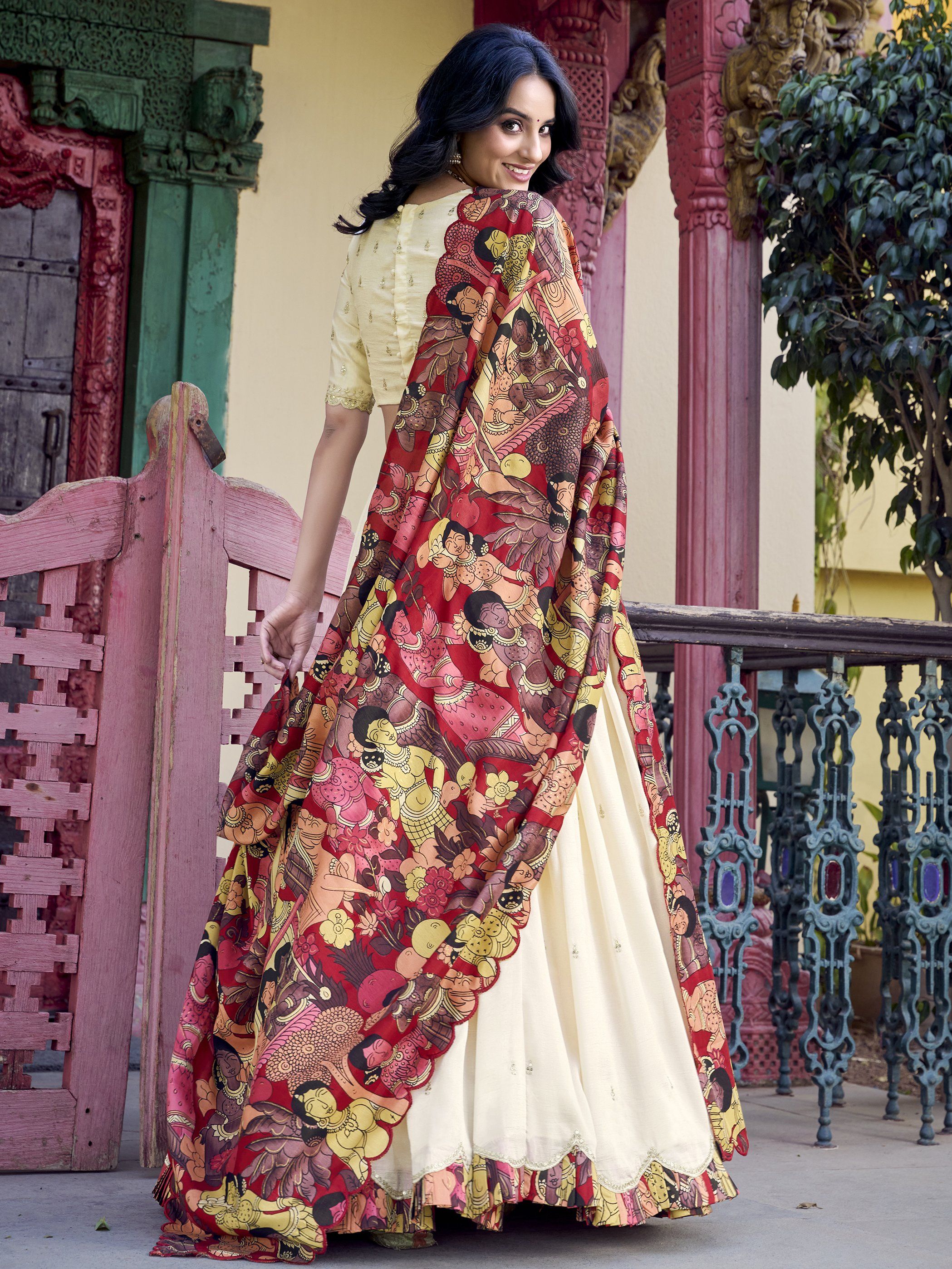 Off-white Vichitra silk lehenga choli with intricate sequin and thread embroidery, 4-meter flair, Kalamkari printed dupatta with scalloped border – a premium festive outfit for weddings and traditional celebrations