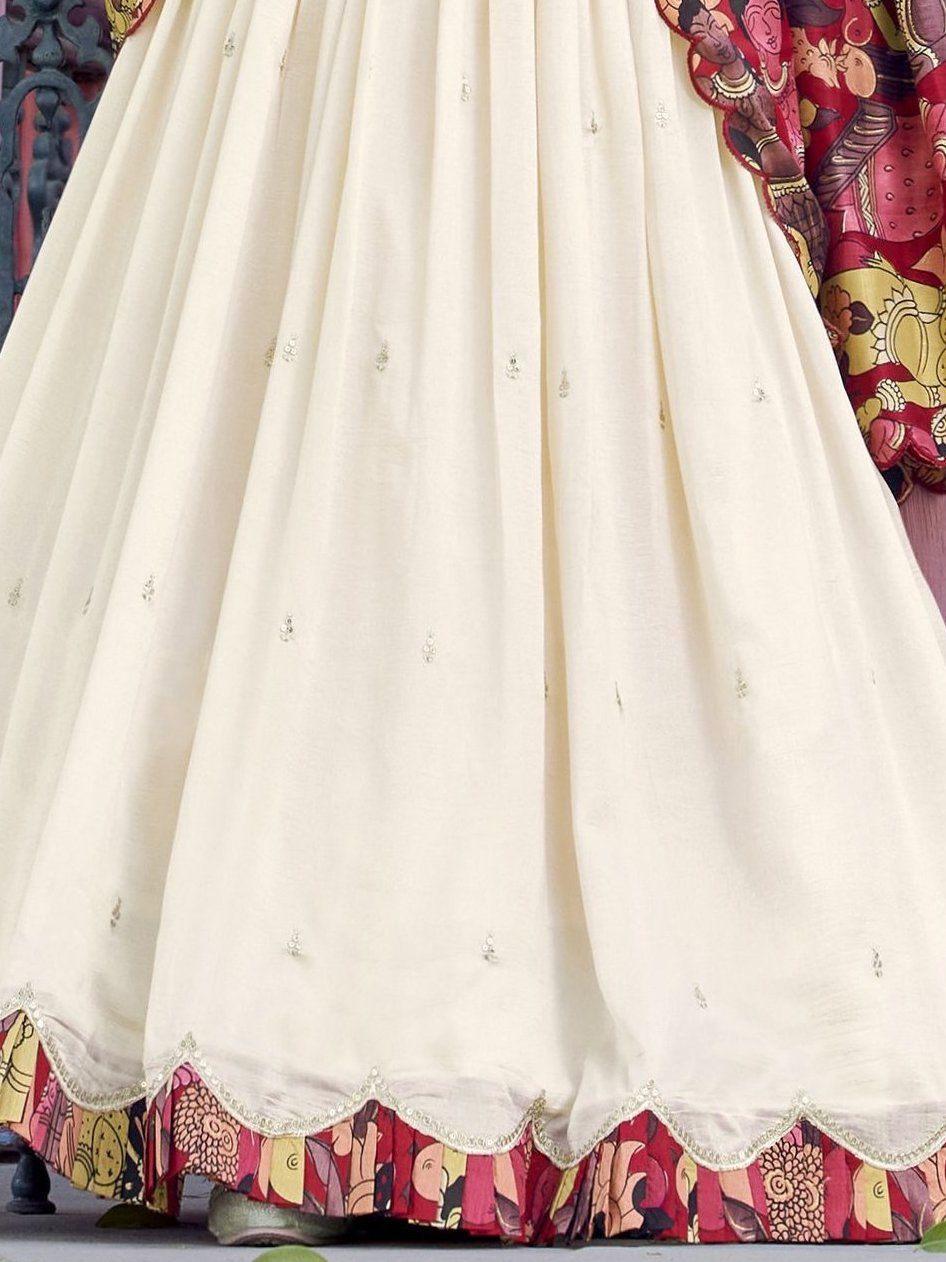 Off-white Vichitra silk lehenga choli with intricate sequin and thread embroidery, 4-meter flair, Kalamkari printed dupatta with scalloped border – a premium festive outfit for weddings and traditional celebrations