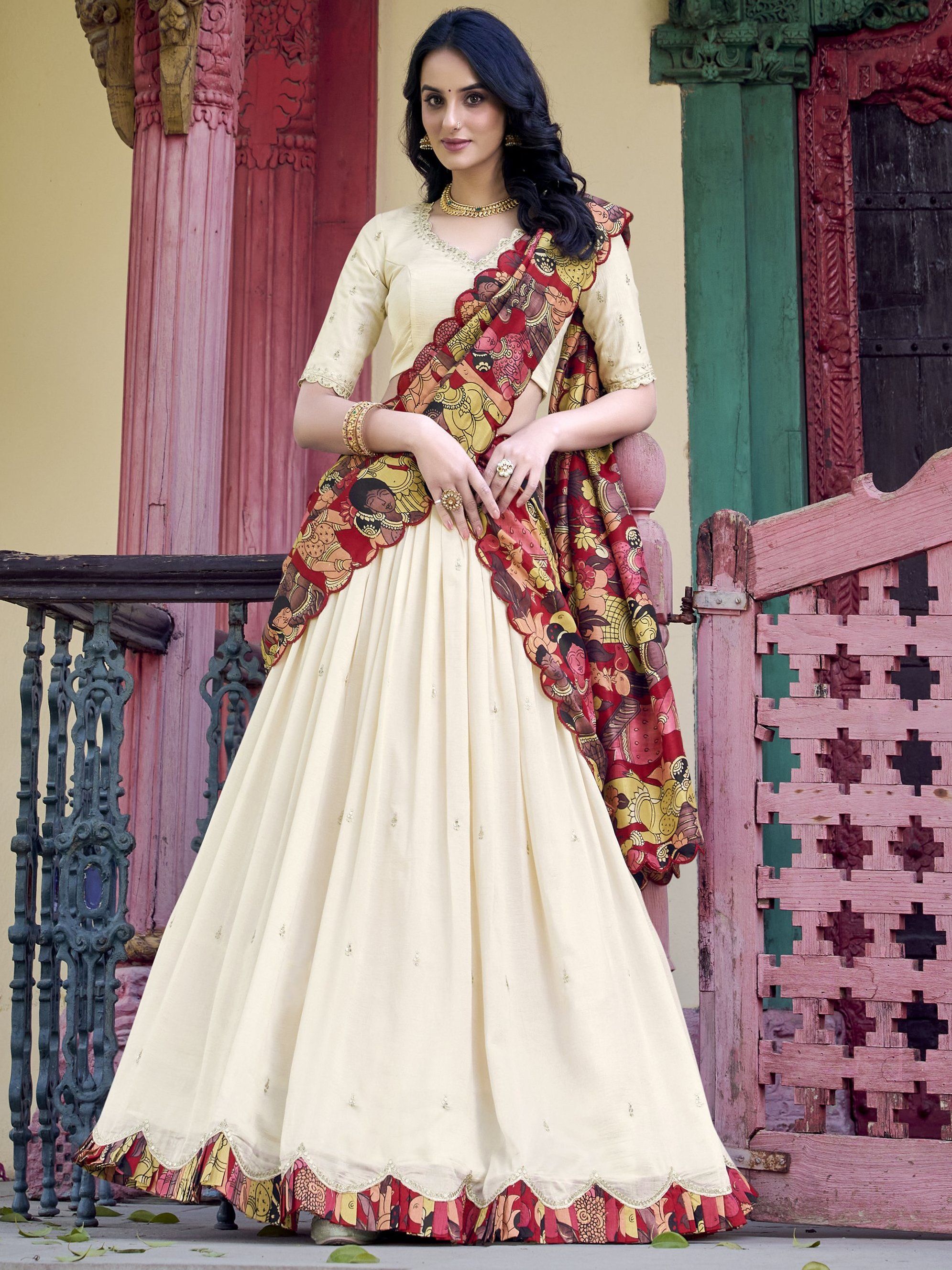 Off-white Vichitra silk lehenga choli with intricate sequin and thread embroidery, 4-meter flair, Kalamkari printed dupatta with scalloped border – a premium festive outfit for weddings and traditional celebrations