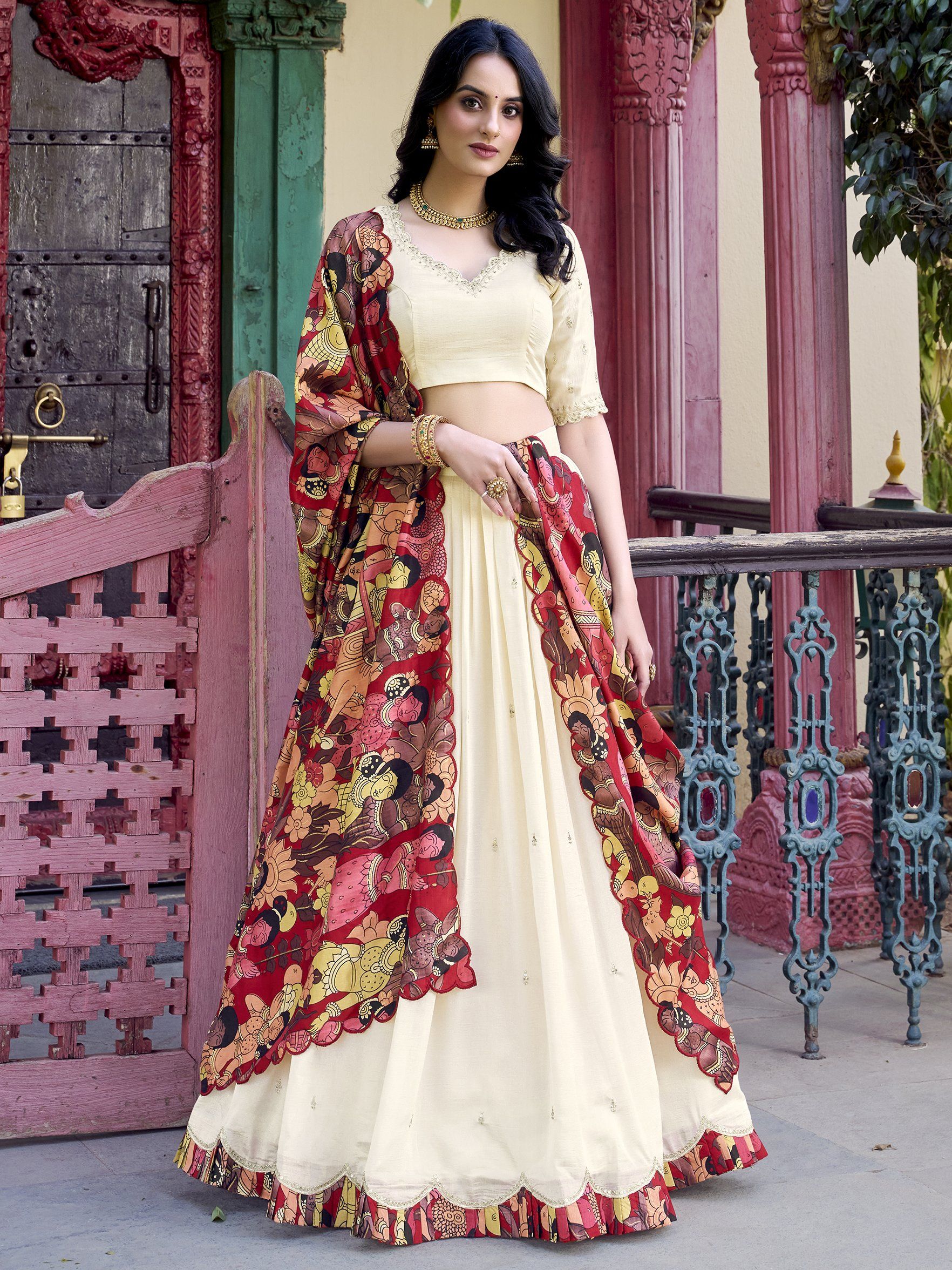 Off-white Vichitra silk lehenga choli with intricate sequin and thread embroidery, 4-meter flair, Kalamkari printed dupatta with scalloped border – a premium festive outfit for weddings and traditional celebrations