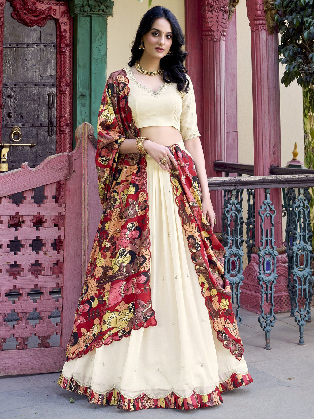 Off-white Vichitra silk lehenga choli with intricate sequin and thread embroidery, 4-meter flair, Kalamkari printed dupatta with scalloped border – a premium festive outfit for weddings and traditional celebrations