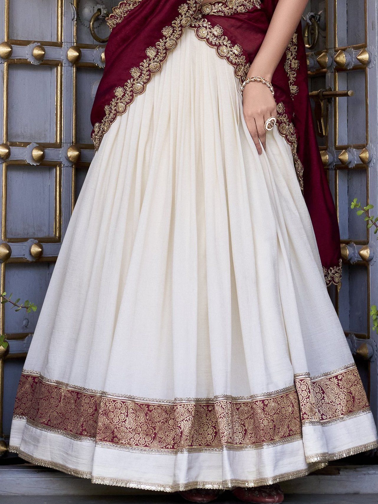 Off-white Vichitra silk lehenga choli set featuring zari weaving, sequins lace border, and embroidered dupatta ideal for weddings and festive celebrations.