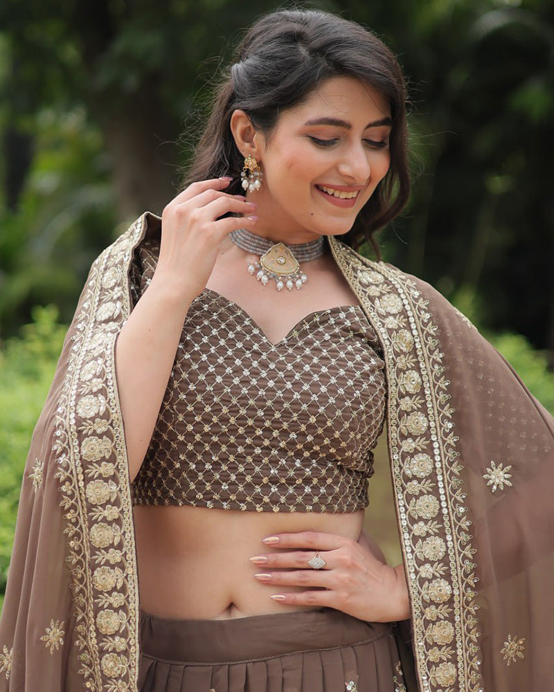Rasika Brown Embroidered Designer Lehenga Choli with Heavy Sequins Work, Faux Blooming Fabric, and Faux Georgette Dupatta – Perfect for Weddings & Festive Wear.
