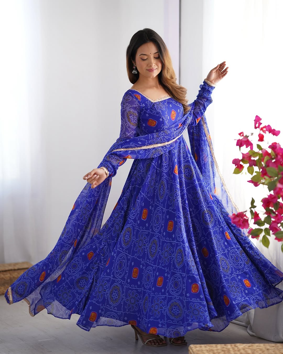 Shanvi Bandhej Chiffon Anarkali Suit Set – blue Bandhej Anarkali gown, traditional chiffon ethnic wear, women’s blue ethnic dress, Bandhej printed Anarkali for weddings, designer ethnic gown, Anarkali suit with lace dupatta, flair Anarkali with full sleeves, Bandhej print ethnic dress, blue festival wear gown, Indian wedding guest Anarkali.