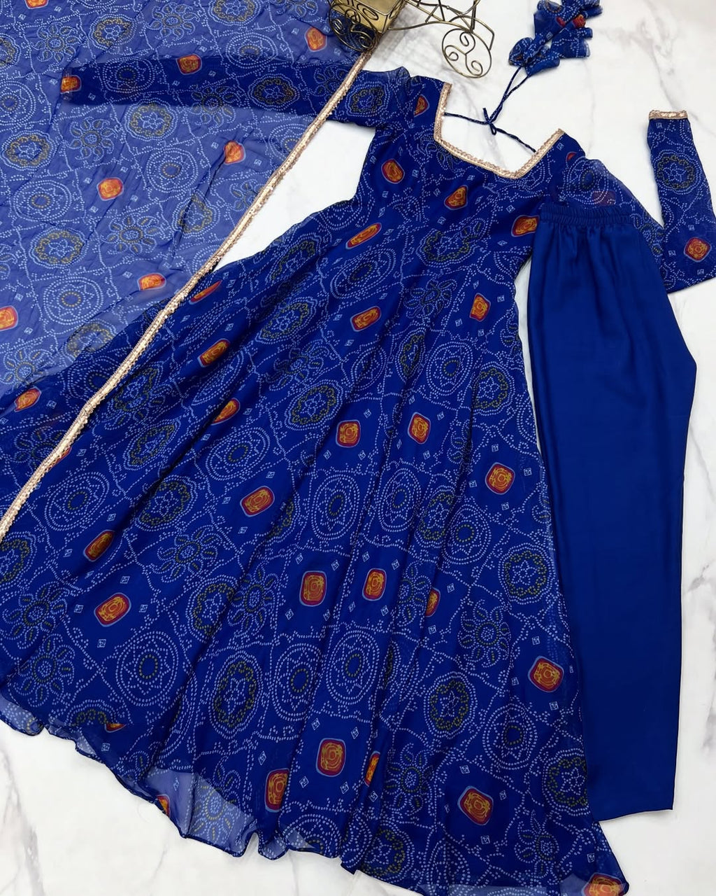 Shanvi Bandhej Chiffon Anarkali Suit Set – blue Bandhej Anarkali gown, traditional chiffon ethnic wear, women’s blue ethnic dress, Bandhej printed Anarkali for weddings, designer ethnic gown, Anarkali suit with lace dupatta, flair Anarkali with full sleeves, Bandhej print ethnic dress, blue festival wear gown, Indian wedding guest Anarkali.