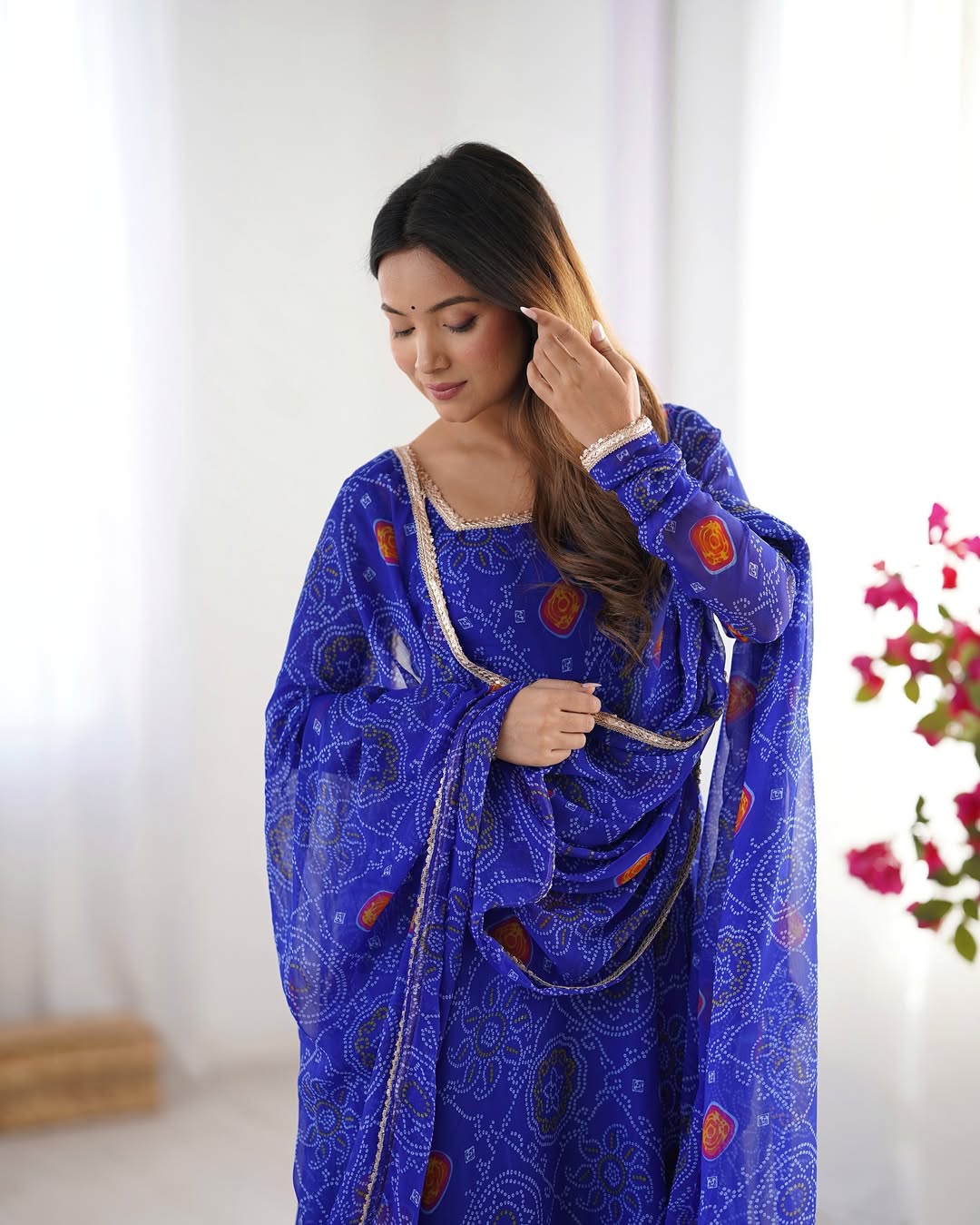Shanvi Bandhej Chiffon Anarkali Suit Set – blue Bandhej Anarkali gown, traditional chiffon ethnic wear, women’s blue ethnic dress, Bandhej printed Anarkali for weddings, designer ethnic gown, Anarkali suit with lace dupatta, flair Anarkali with full sleeves, Bandhej print ethnic dress, blue festival wear gown, Indian wedding guest Anarkali.