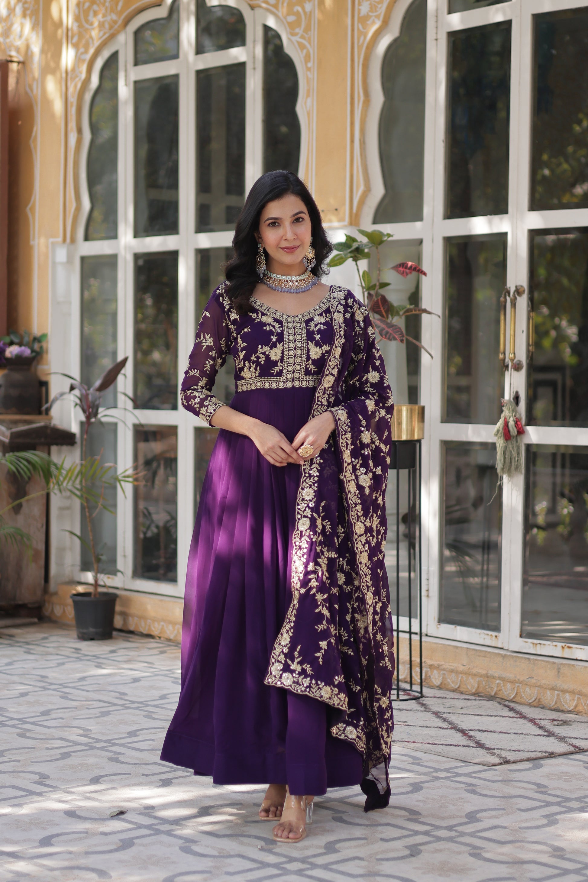  Shivangi purple embroidered Anarkali gown set featuring faux blooming fabric, zari and multi-sequins work, 3/4 sleeves, and a designer neck, paired with embroidered faux georgette dupatta – ideal ethnic outfit for weddings, festivals, and party wear in 2025.