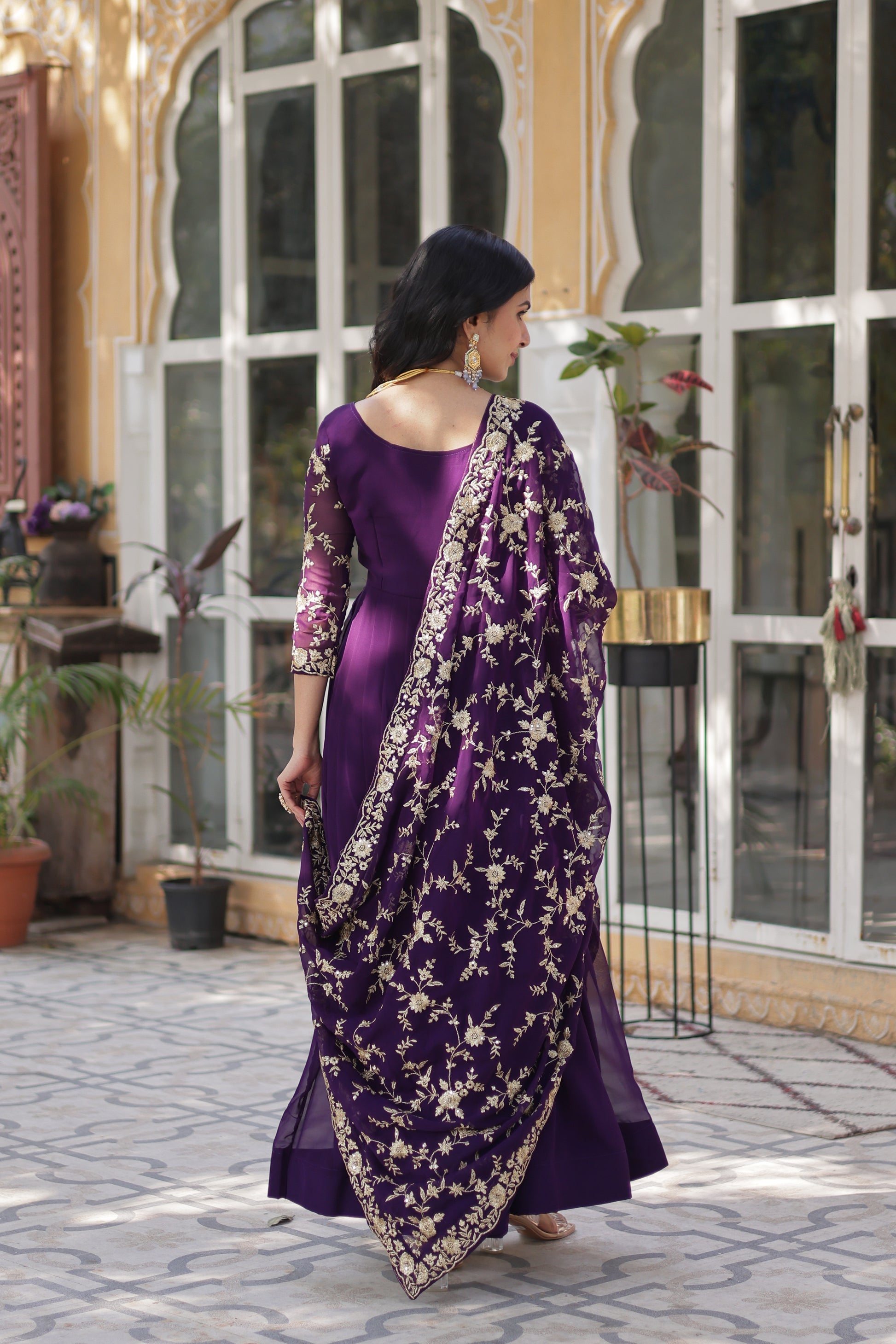  Shivangi purple embroidered Anarkali gown set featuring faux blooming fabric, zari and multi-sequins work, 3/4 sleeves, and a designer neck, paired with embroidered faux georgette dupatta – ideal ethnic outfit for weddings, festivals, and party wear in 2025.